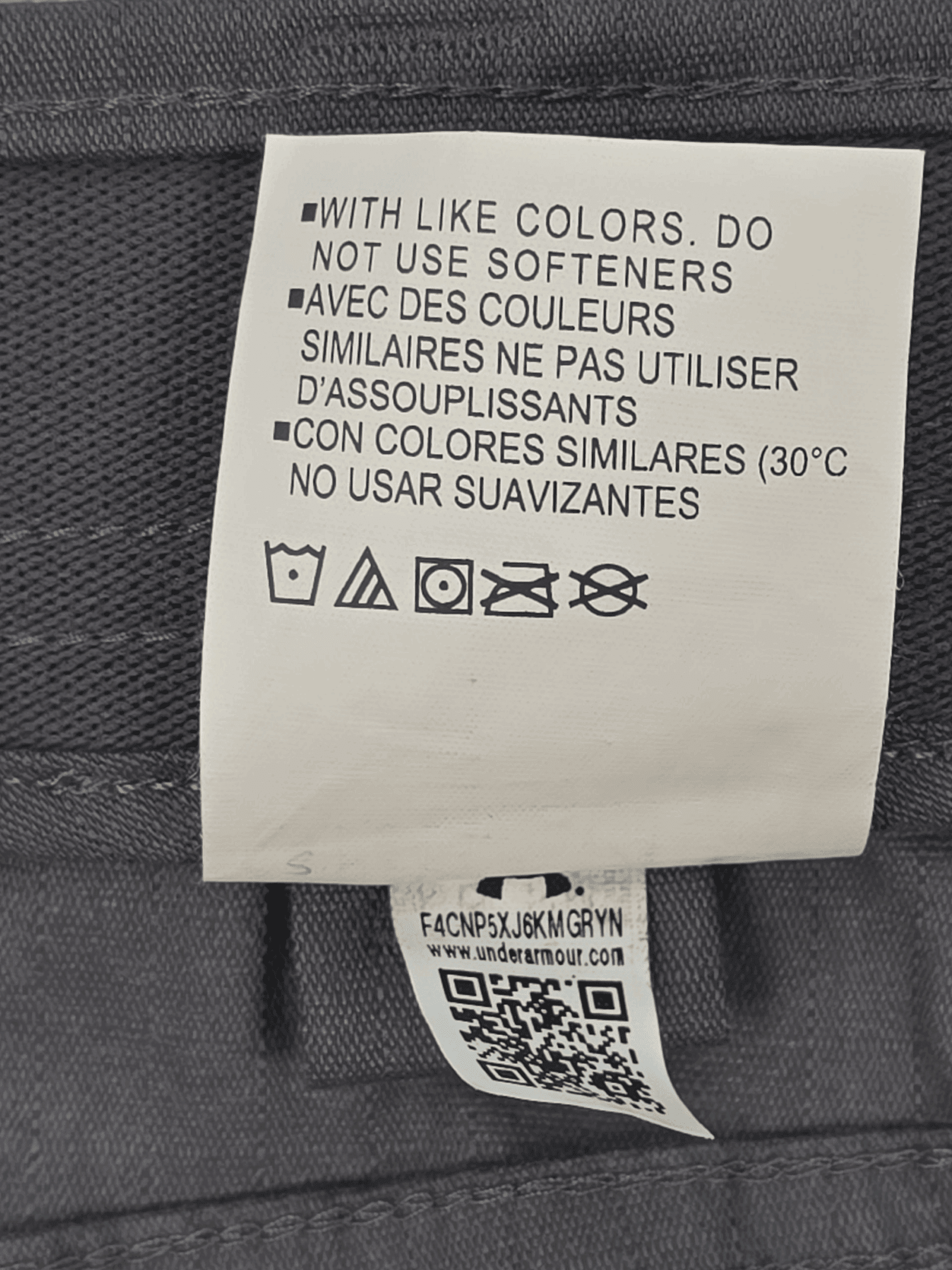 Close-up of material content and garment care tag on Under Armour men’s Big & Tall size 44 Storm Quick-Dry ripstop pants