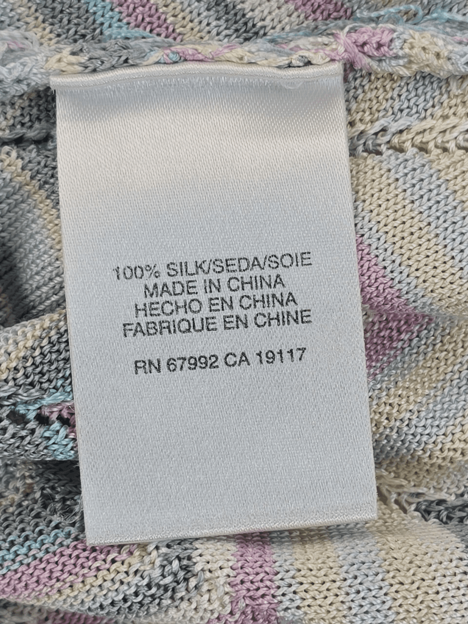 Clothing label showing fabric composition and manufacturing details.