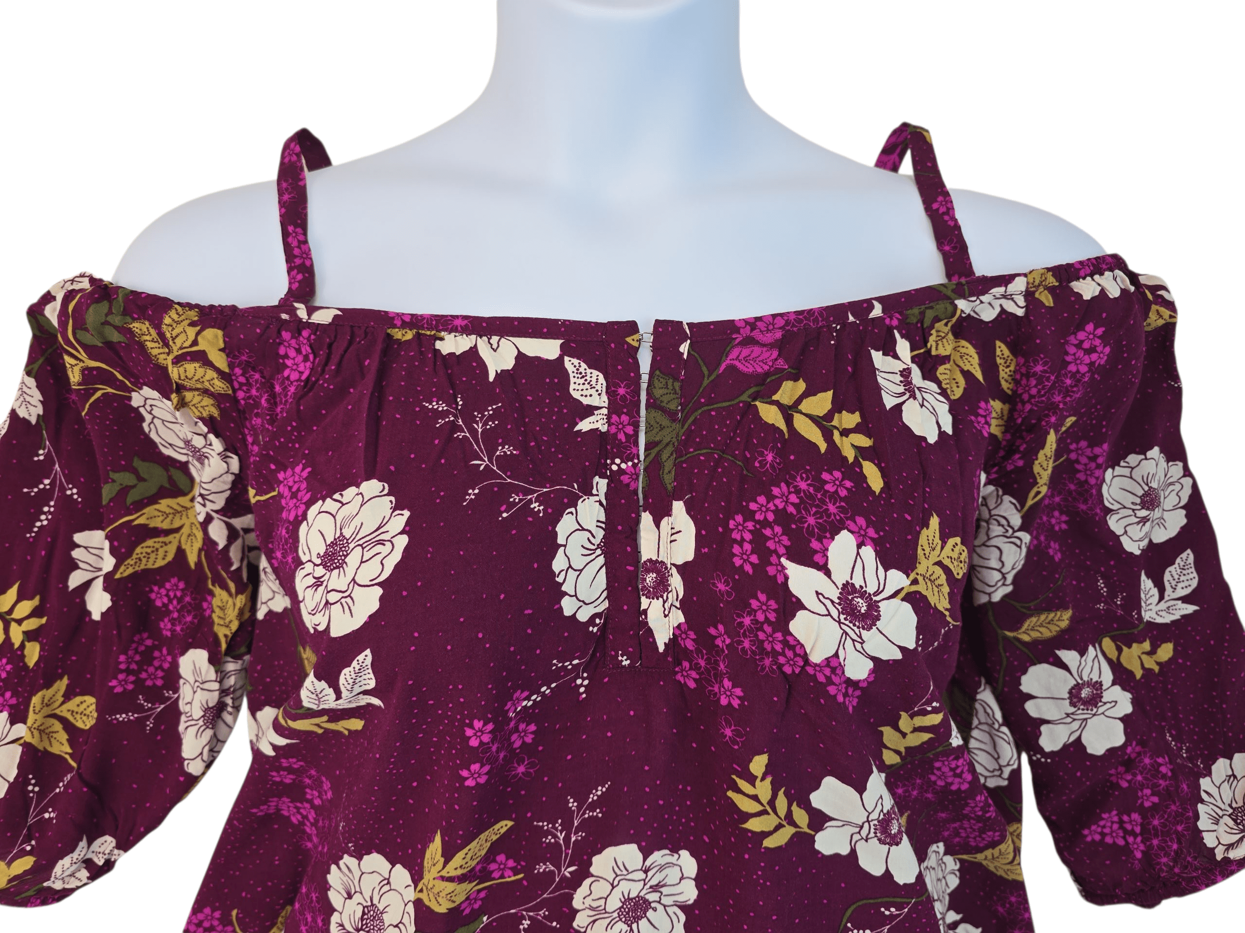 Close-up of a purple floral off-shoulder dress on a mannequin.