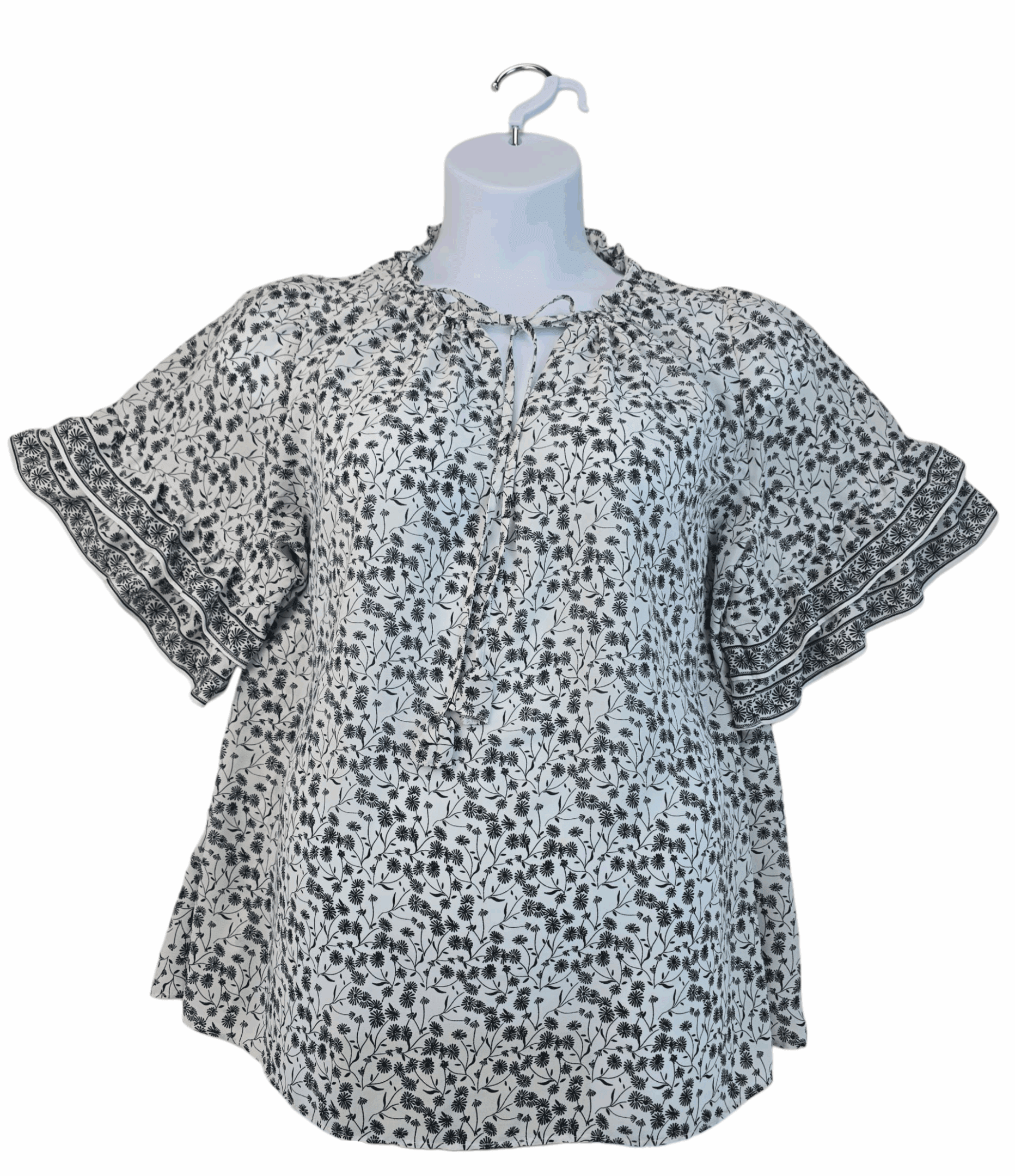 Floral-patterned short-sleeve blouse on a mannequin.