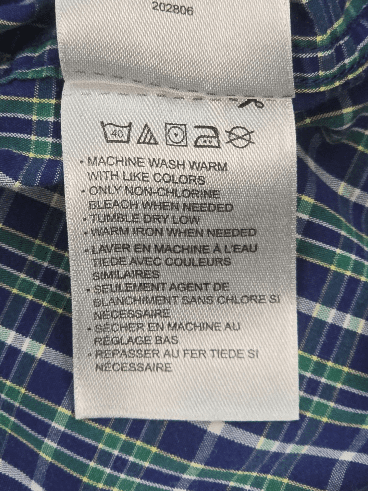 Garment care tag for True Nation green and blue checked short sleeve shirt showing washing and drying directions.