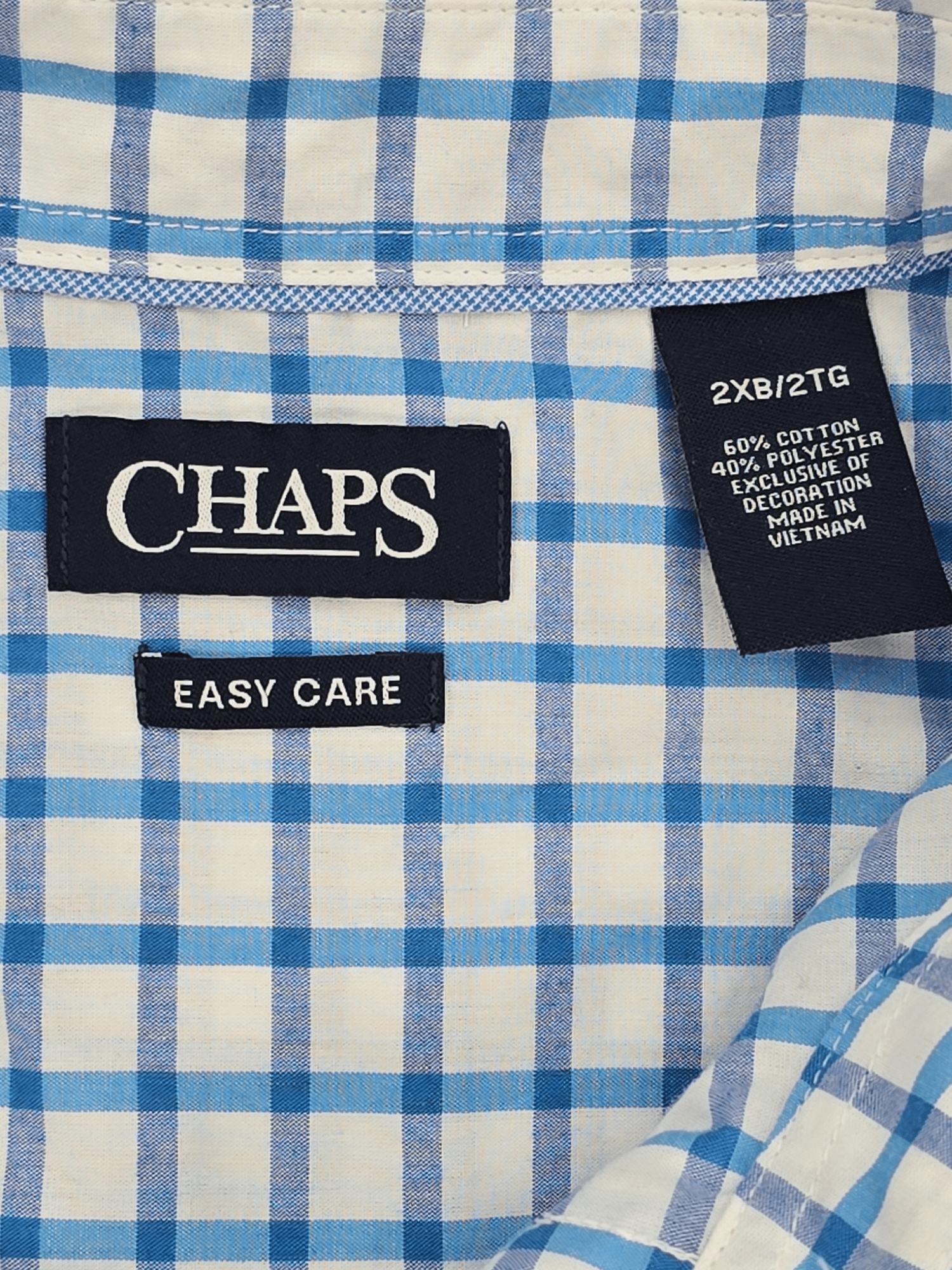 Material content tag listing cotton and polyester blend for Chaps Easy Care blue checked short sleeve shirt.