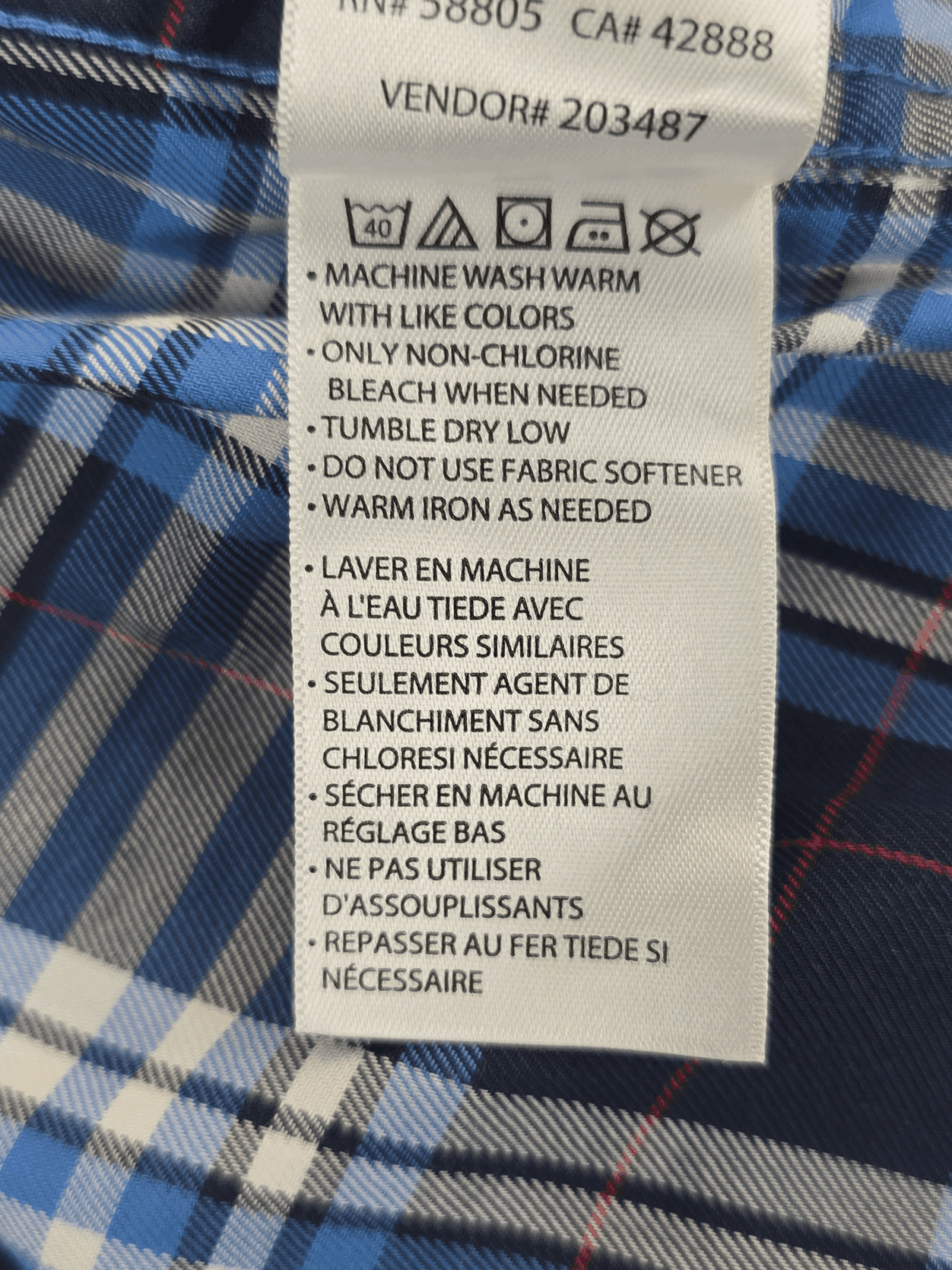 Garment care tag for Oak Hill blue and white plaid wrinkle-free button-up shirt showing washing and drying directions.