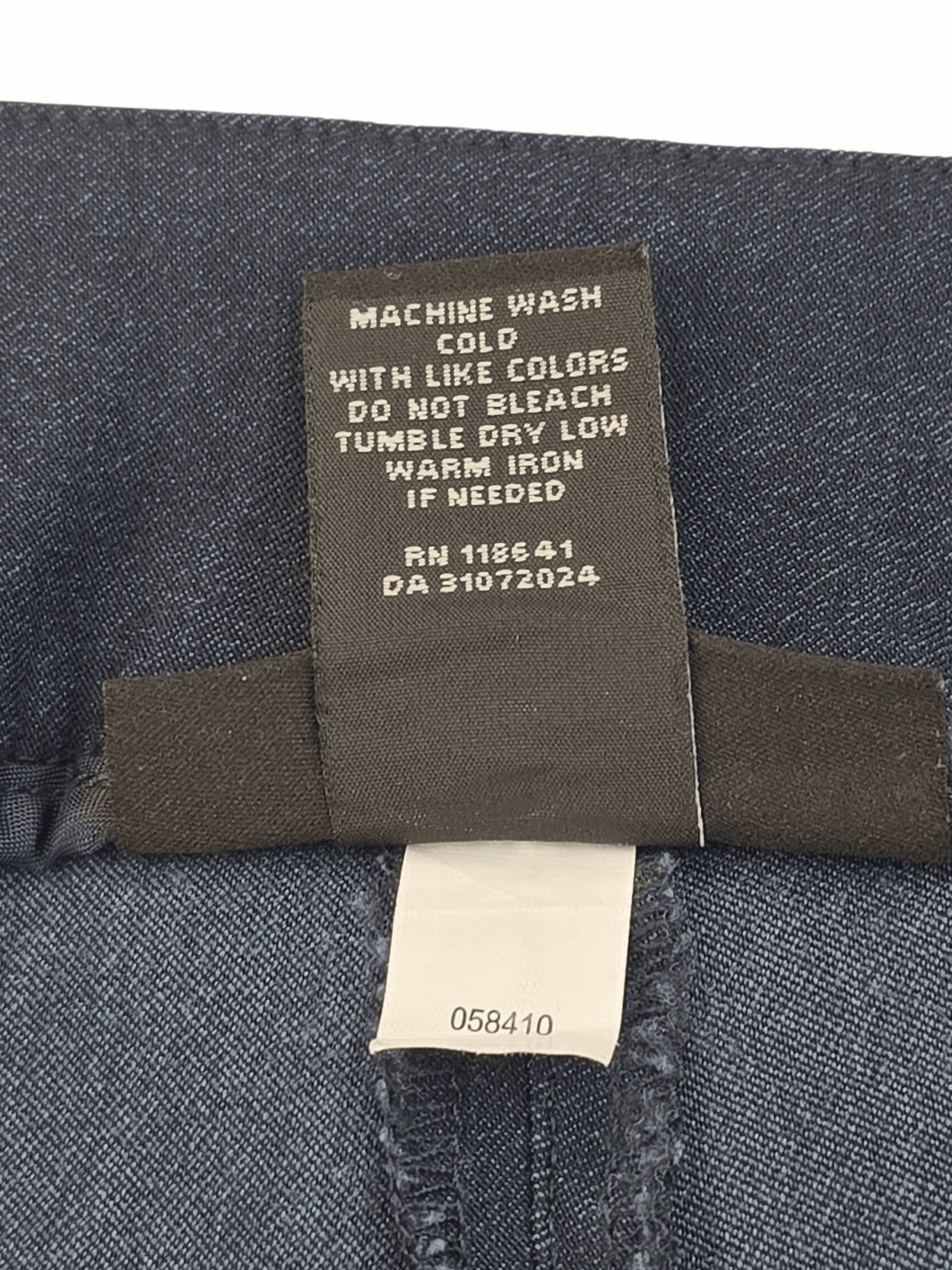 Close-up of clothing care label with washing instructions.