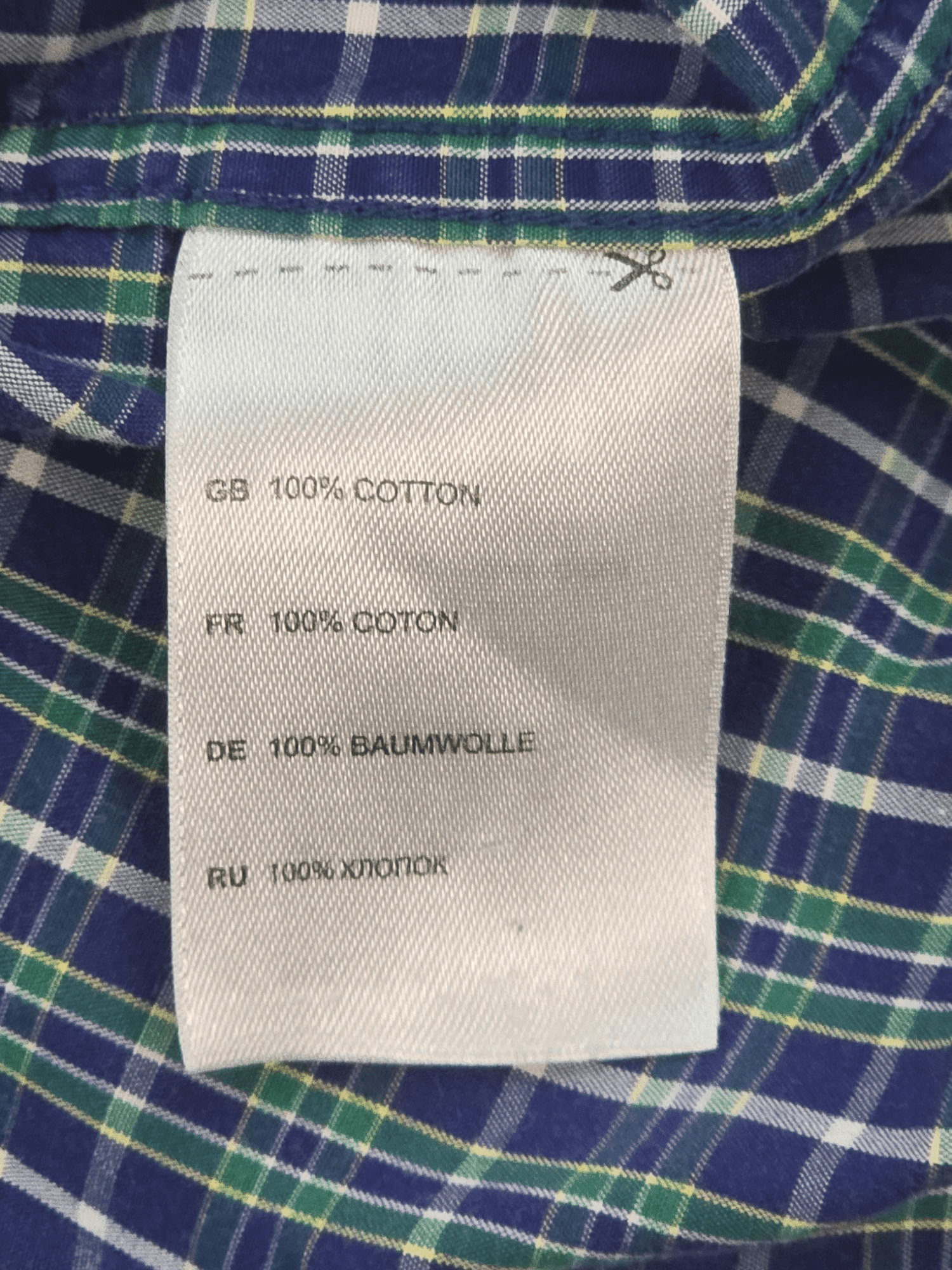 Material content tag listing cotton and polyester blend for True Nation green and blue checked short sleeve shirt.