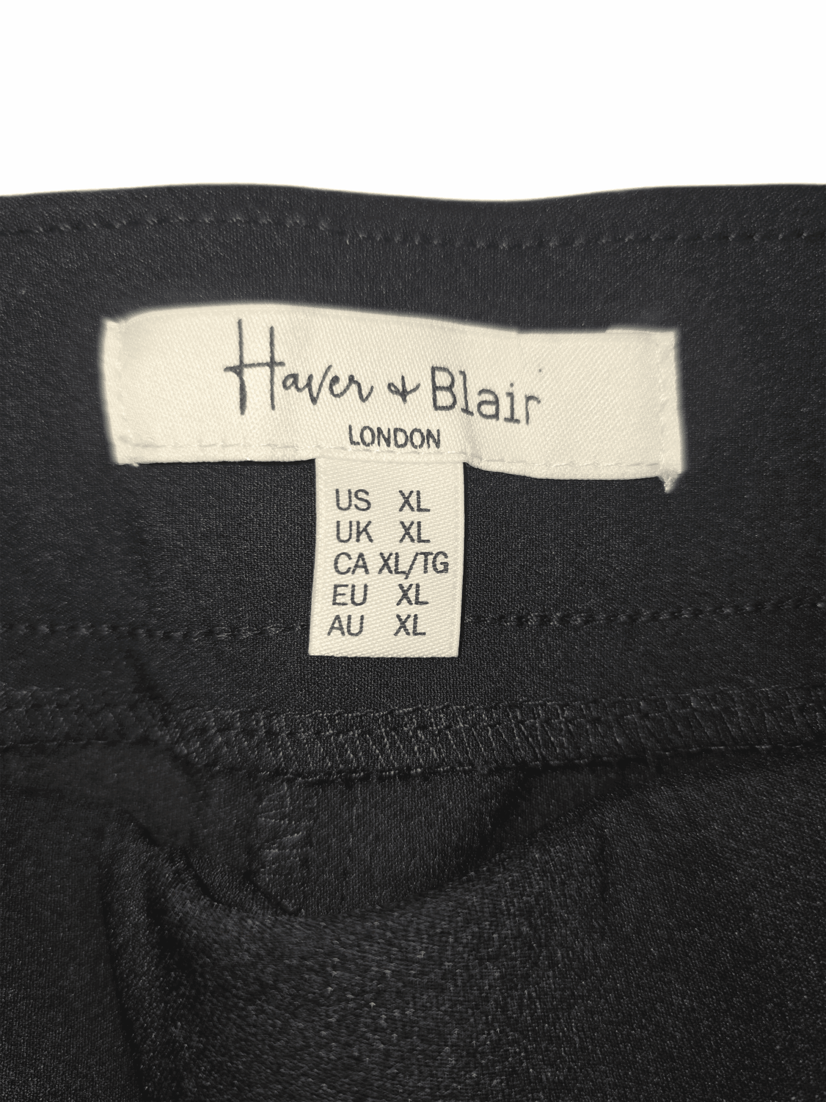 Clothing label showing sizes for Heaven + Blair London.