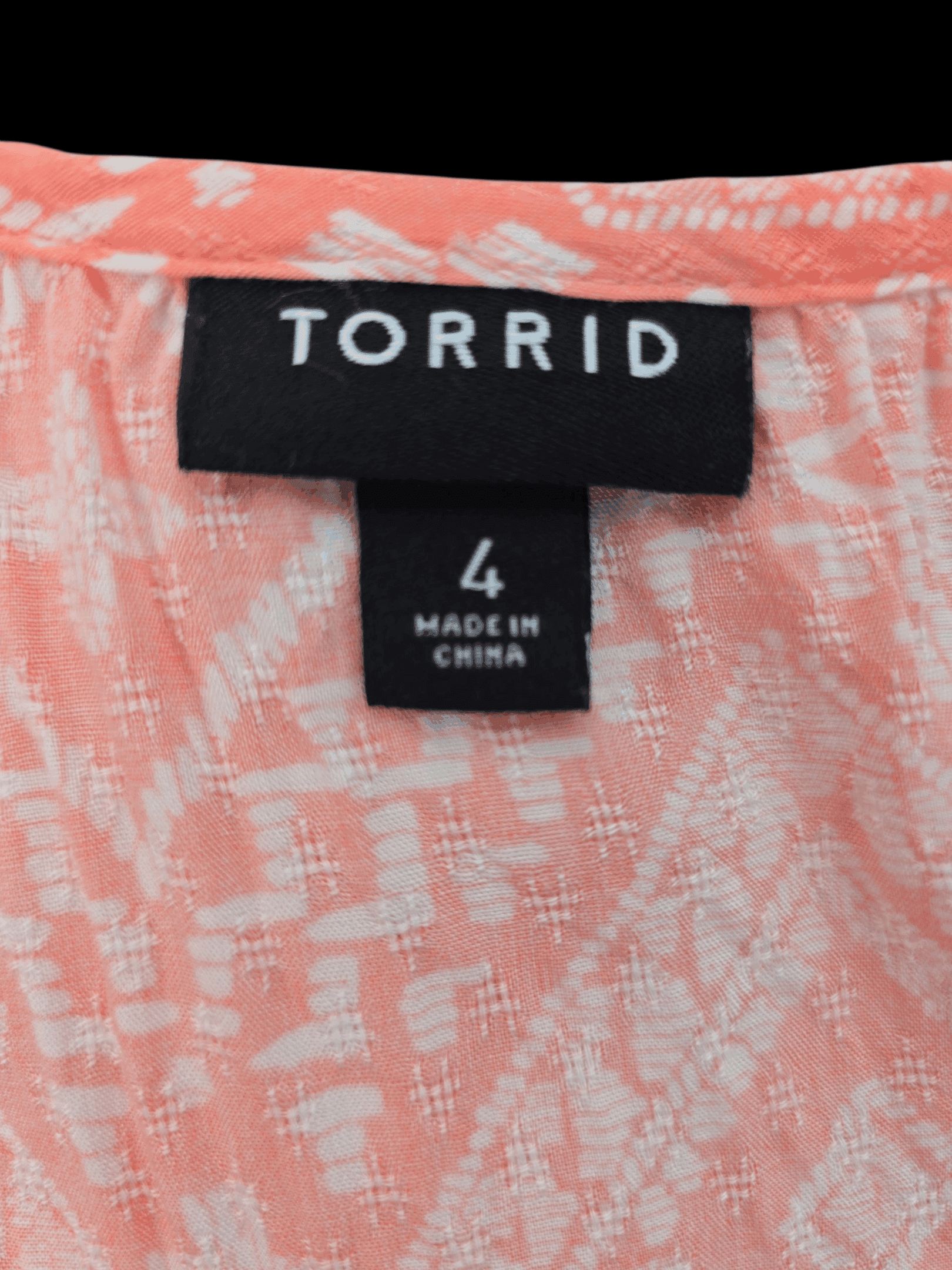 Clothing label showing brand Torrid, size 4, made in China.