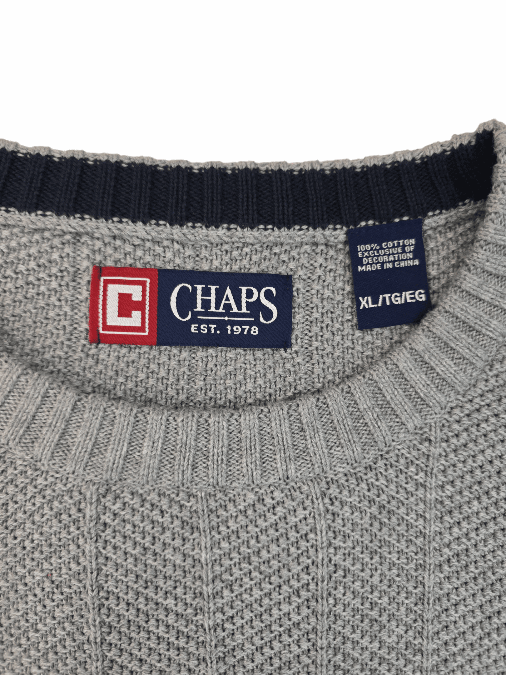 Close-up of a gray Chaps knit sweater collar with brand labels.