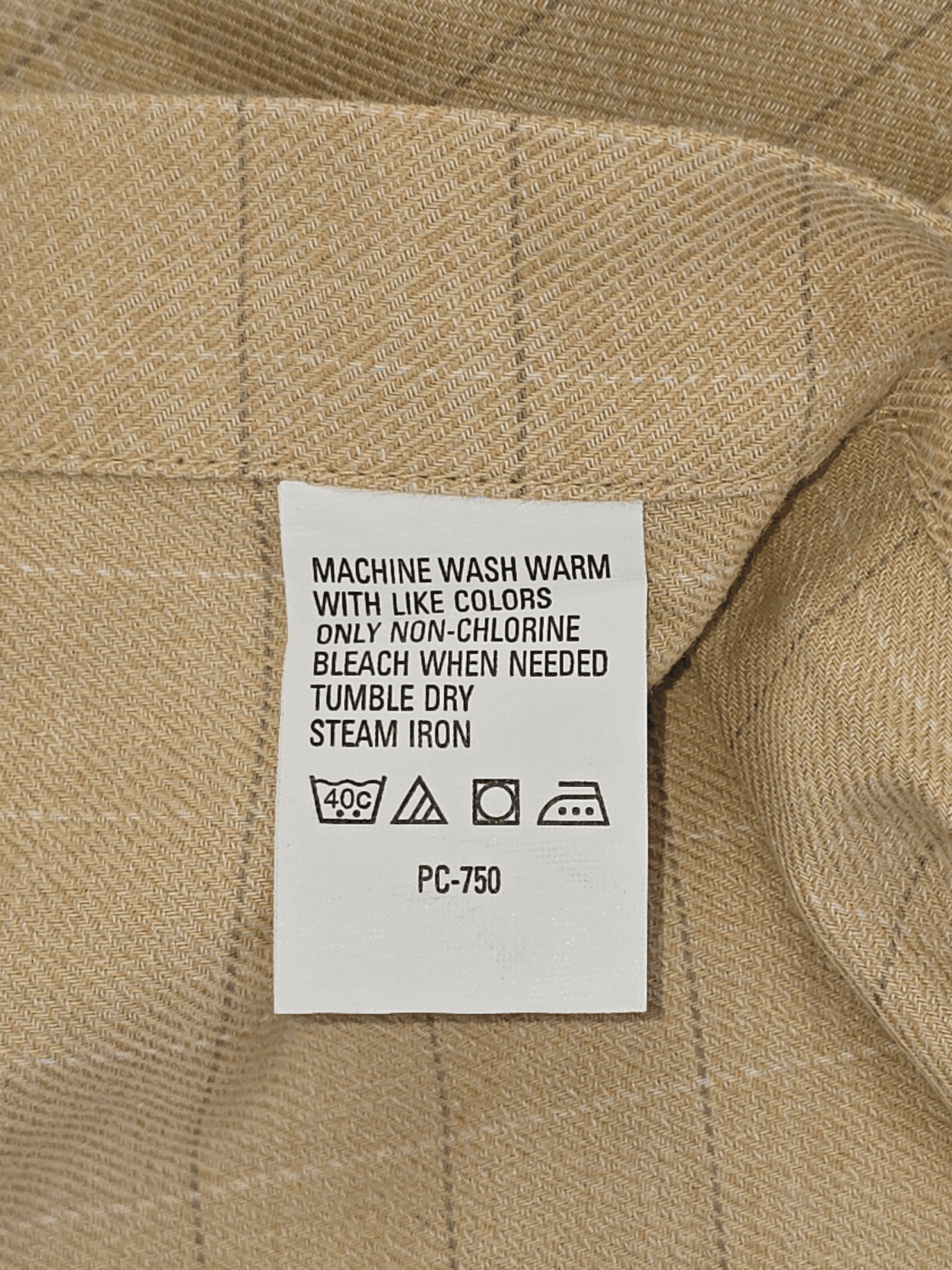 Garment care tag for Geoffrey Beene yellow striped button-up shirt showing washing and ironing directions.