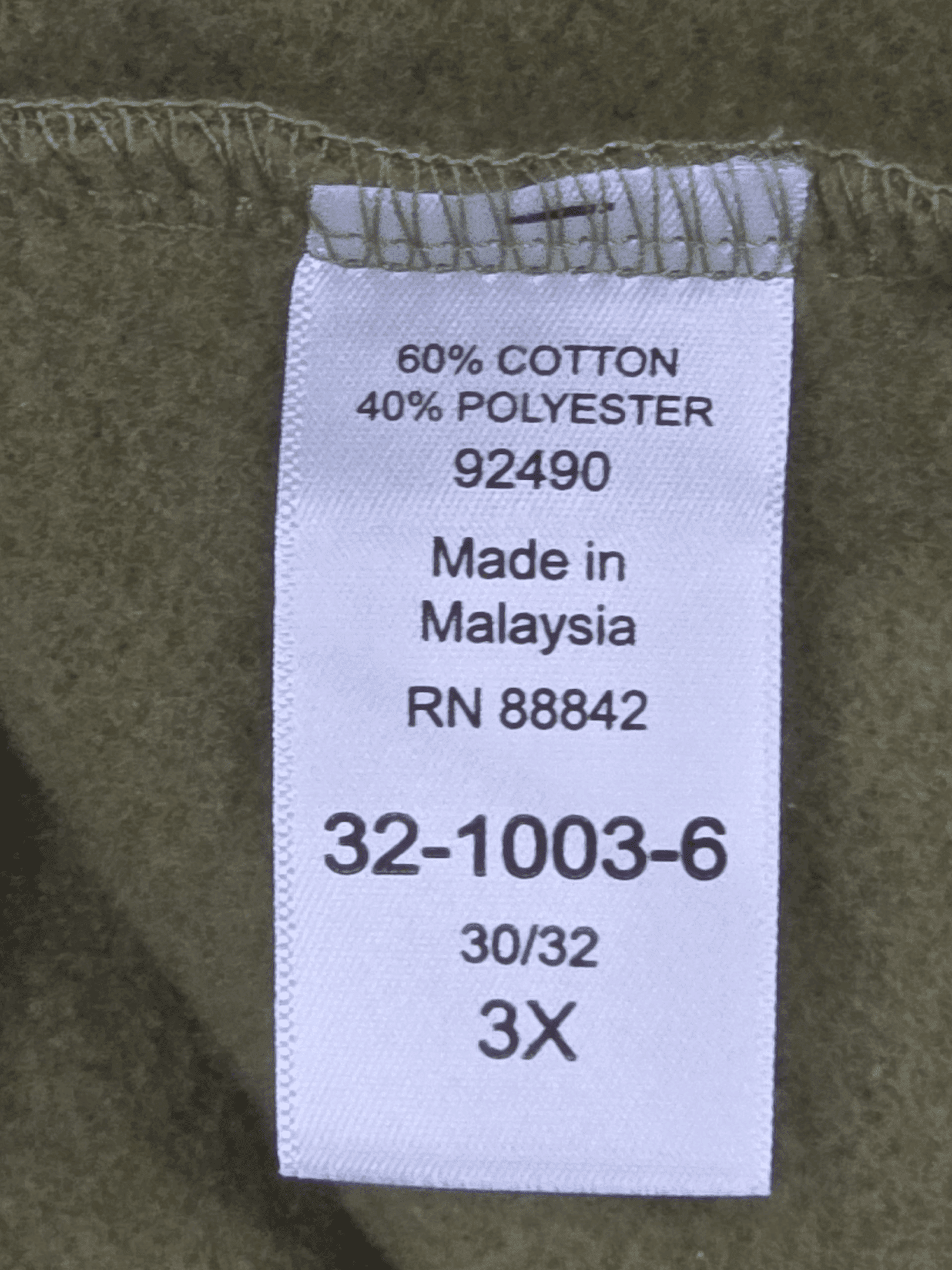 Clothing label showing material composition and size information.