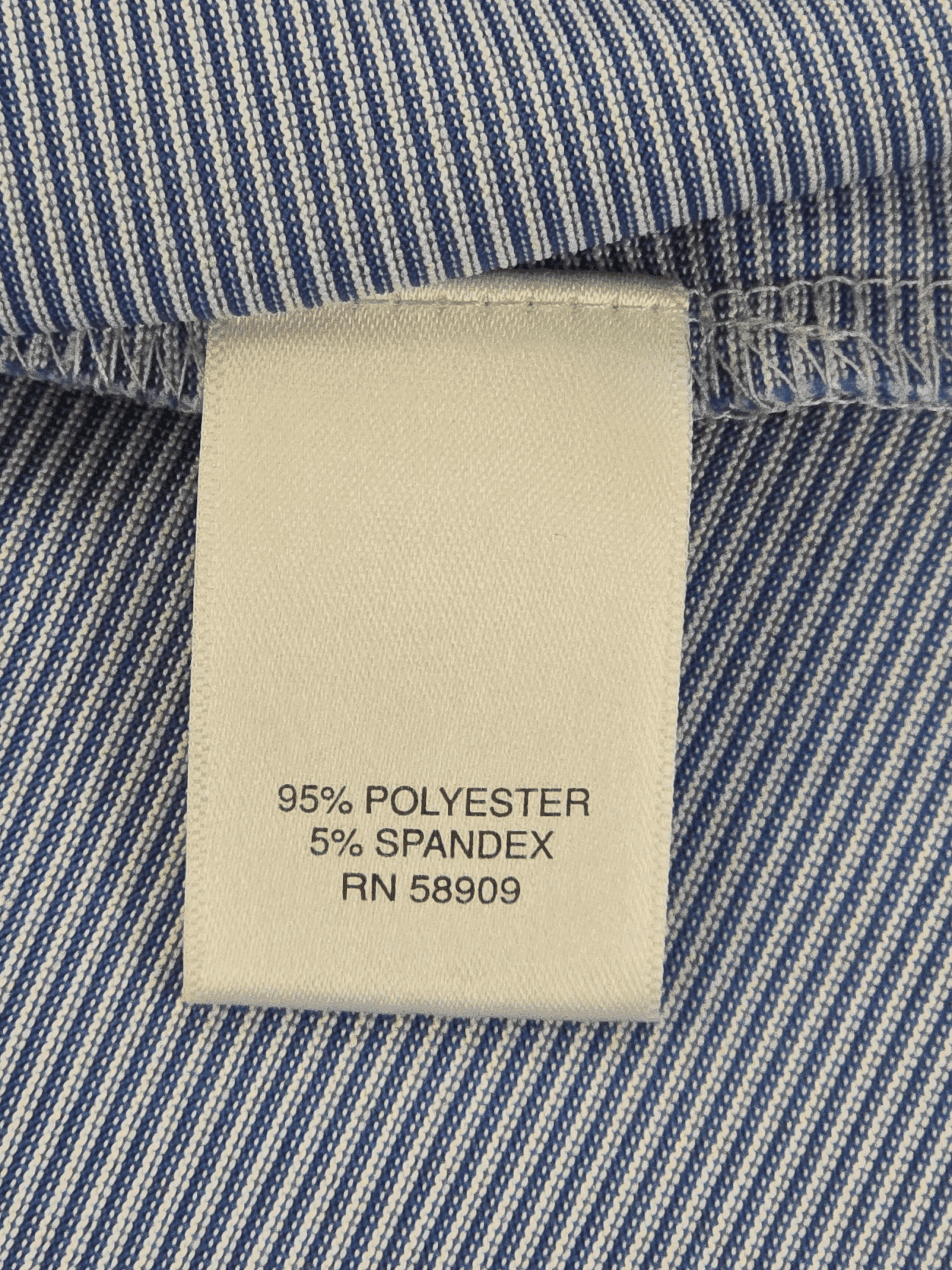 Clothing label showing fabric composition and care information.