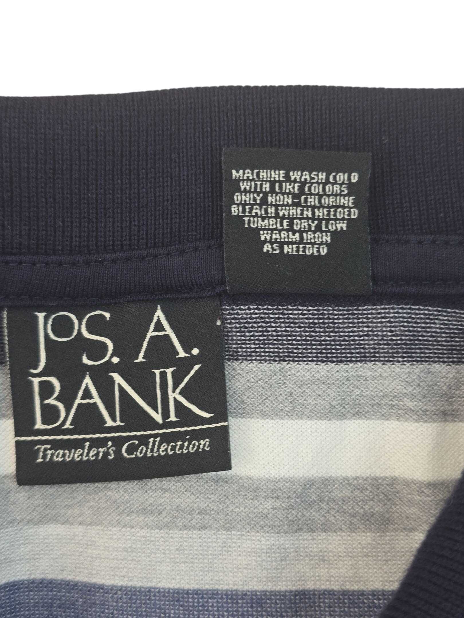 Close-up of Jos. A. Bank clothing labels on a striped fabric.