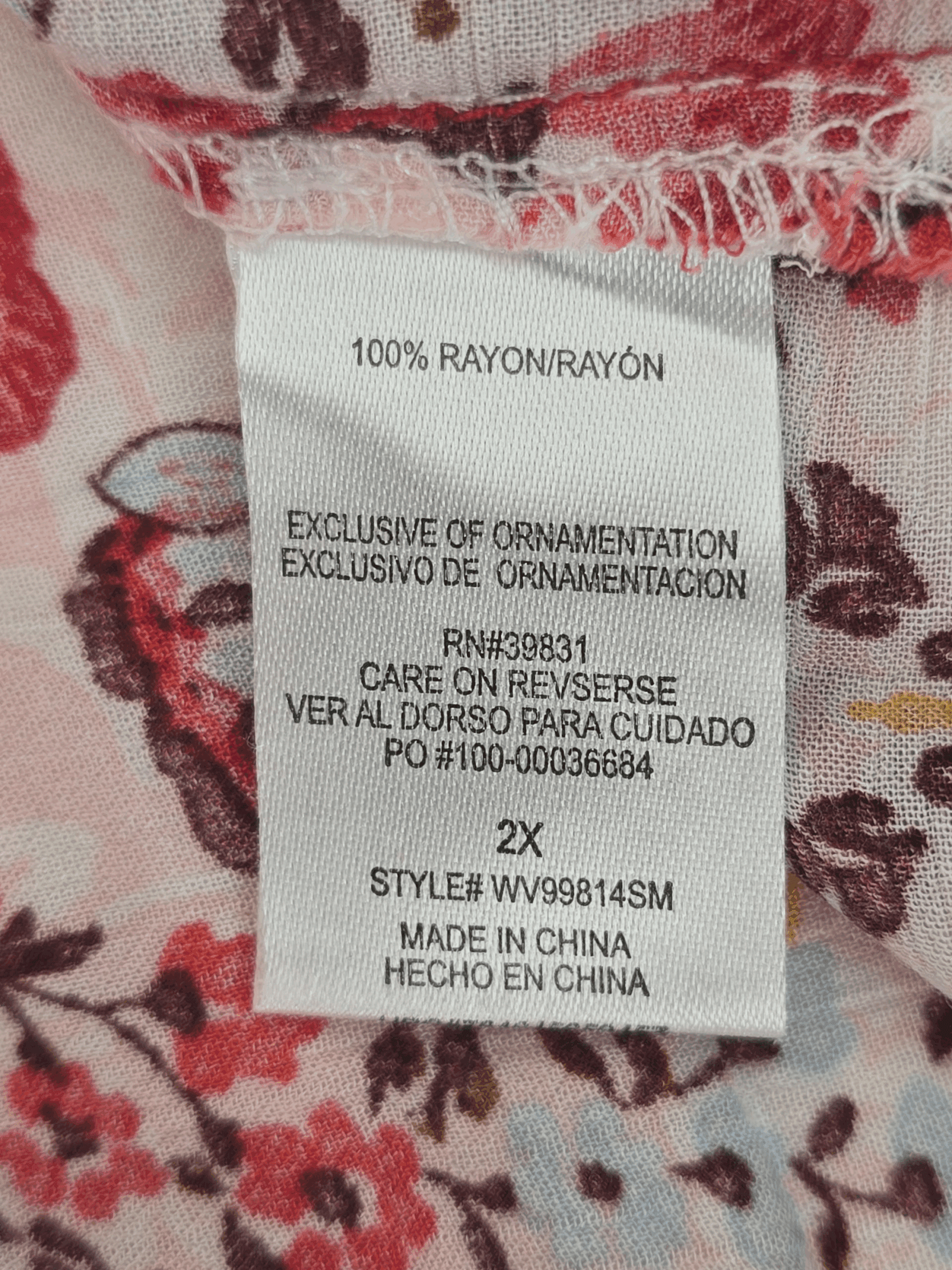 Material content tag listing rayon and spandex blend for Democracy boho cold shoulder lace-up top.