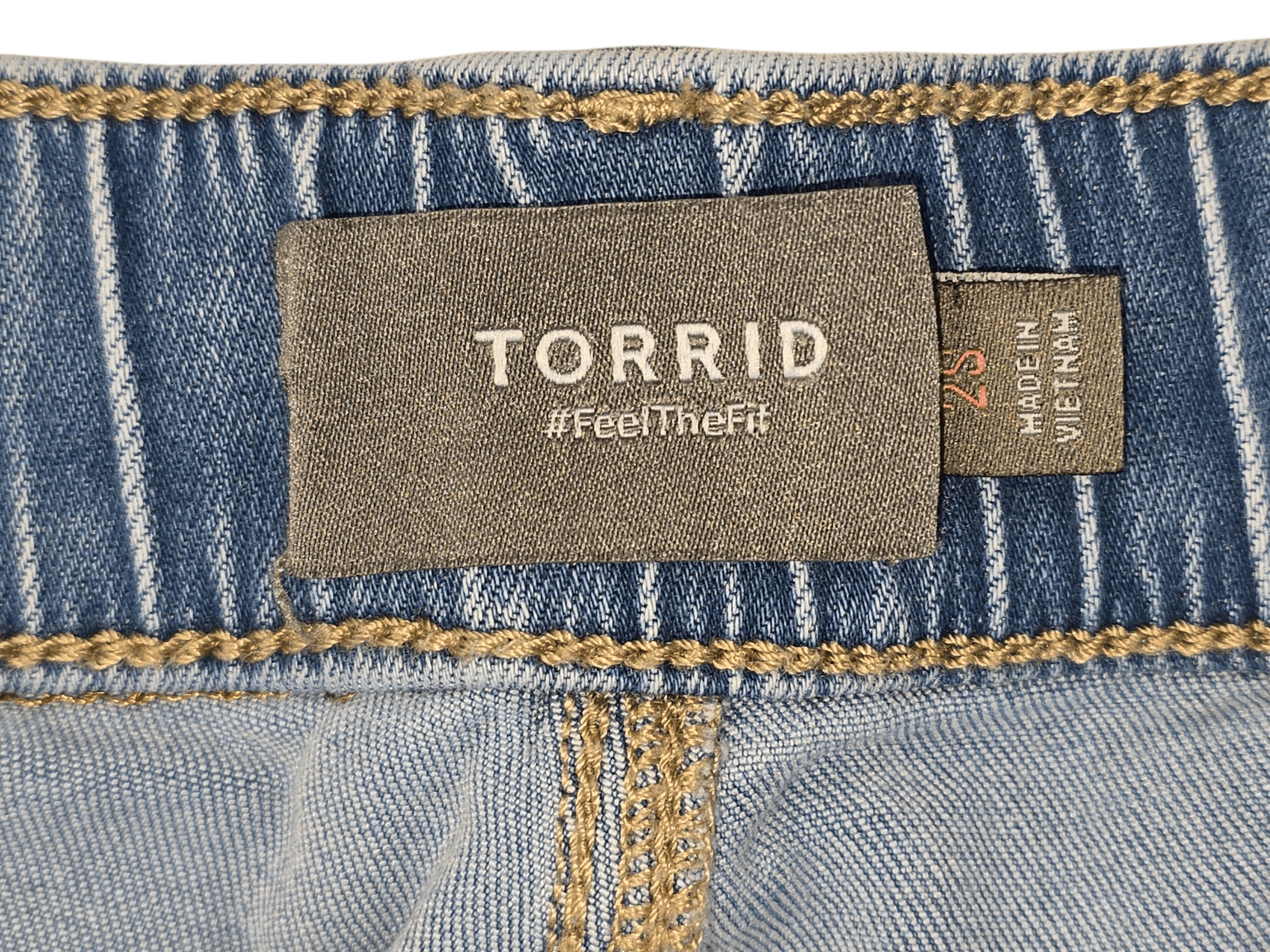 Torrid brand and size tag on light blue denim ankle pants in women’s size 2 short.
