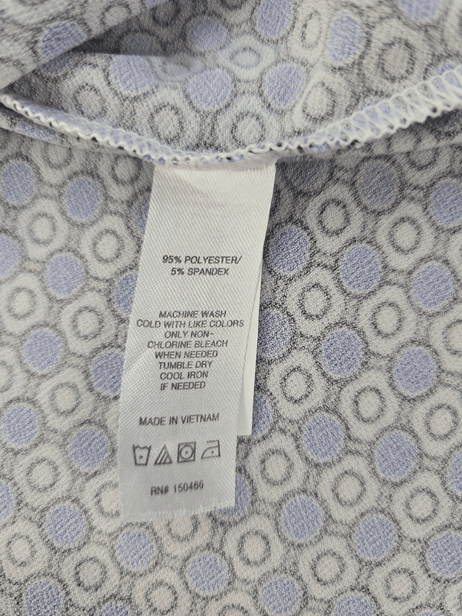 Close-up of a clothing tag showing fabric and care instructions.