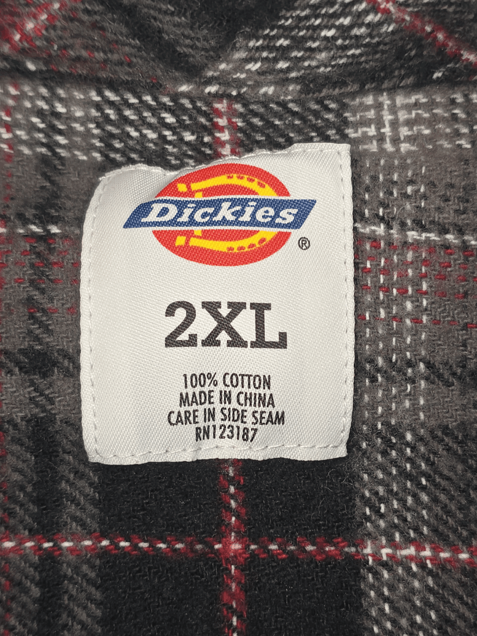 Fabric content tag from Dickies gray, black, and red plaid flannel shirt men’s size 2XL