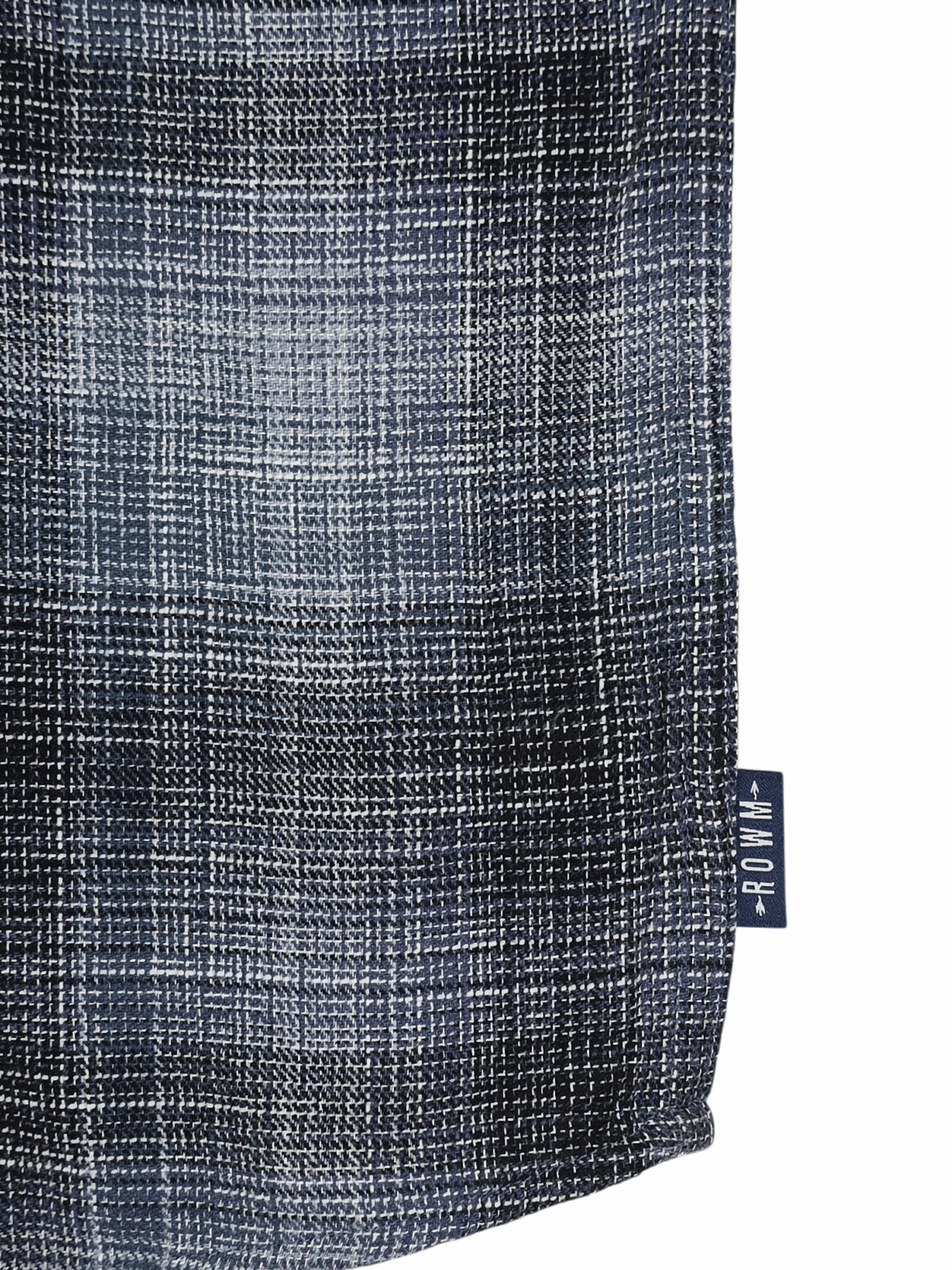 Close-up of a textured fabric with a blue and gray plaid pattern.