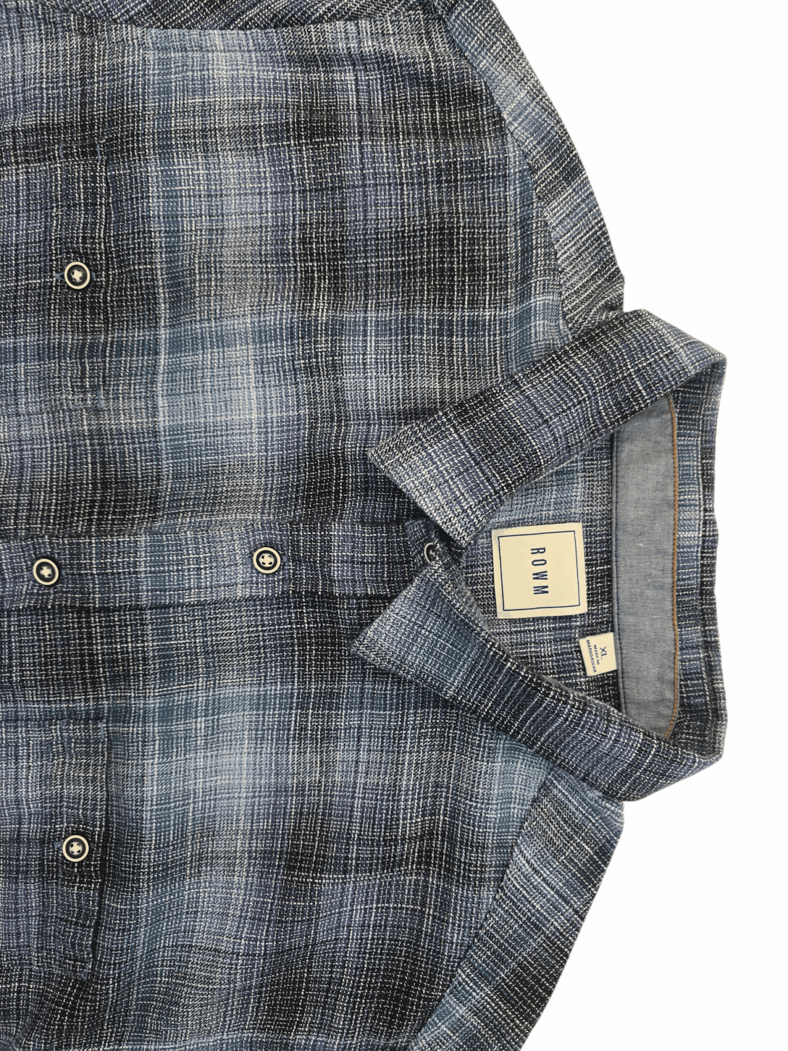 A folded blue and gray plaid shirt with buttons and a visible label.