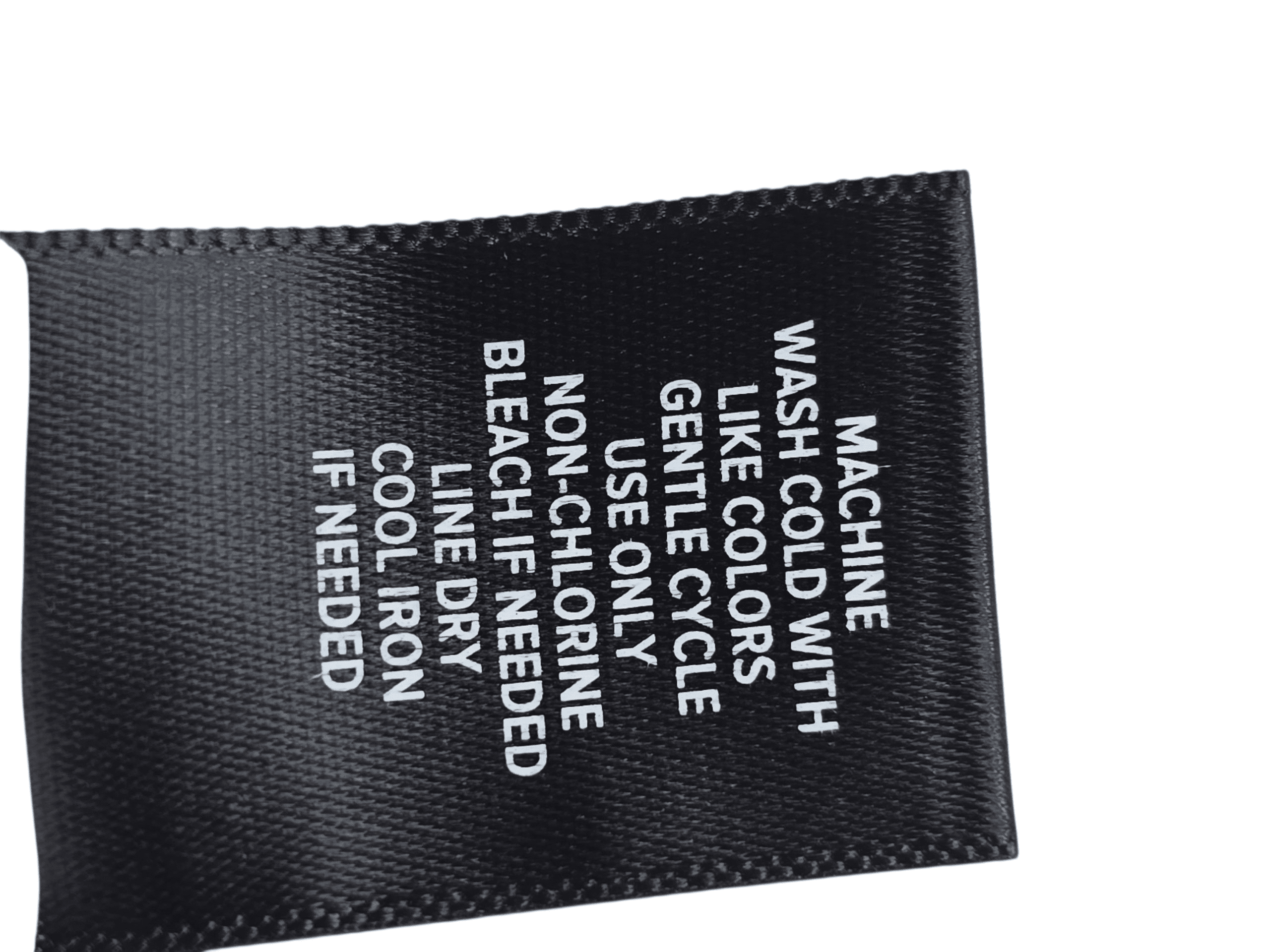 Clothing care label with washing and ironing instructions.