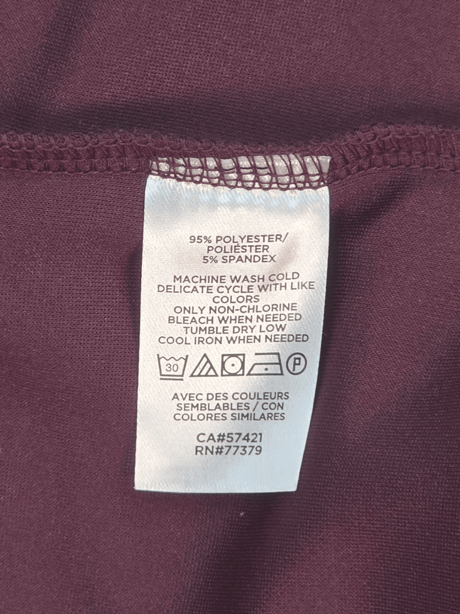 Material content tag listing rayon, nylon, and spandex blend for Ann Taylor plum high neck pullover top.