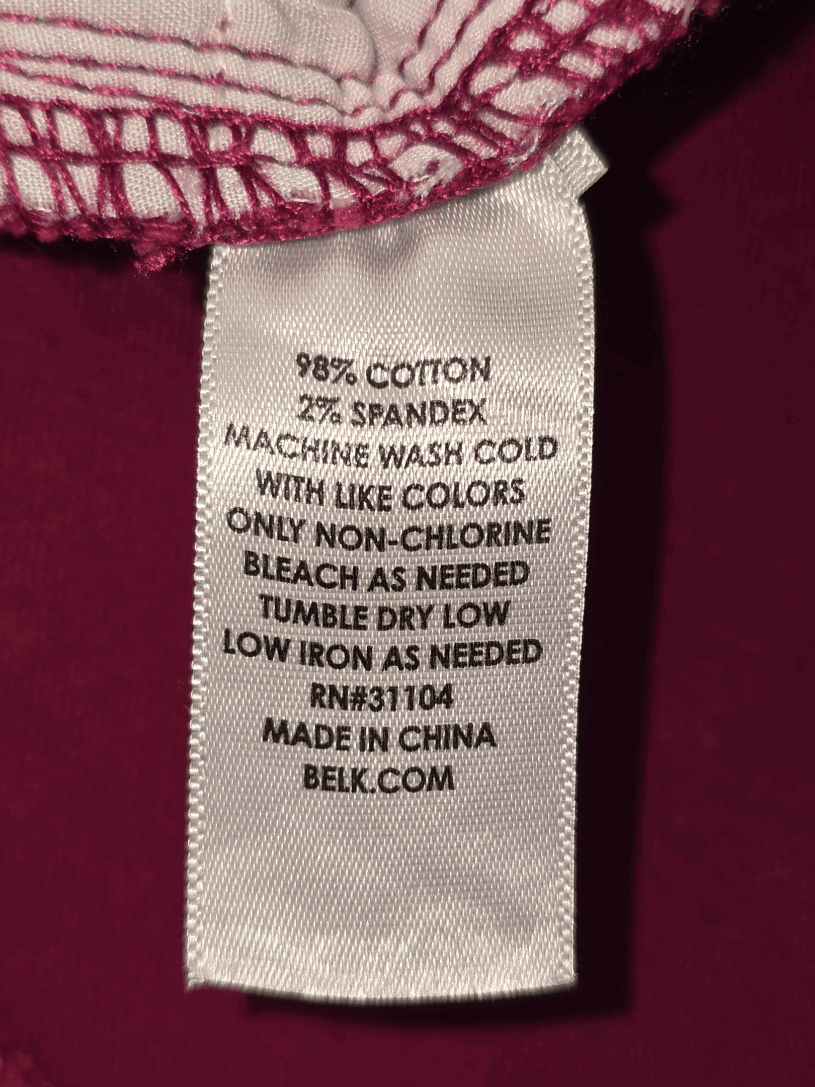 Fabric content tag from Crown & Ivy wine-colored twill skinny jeans women’s size 14 regular