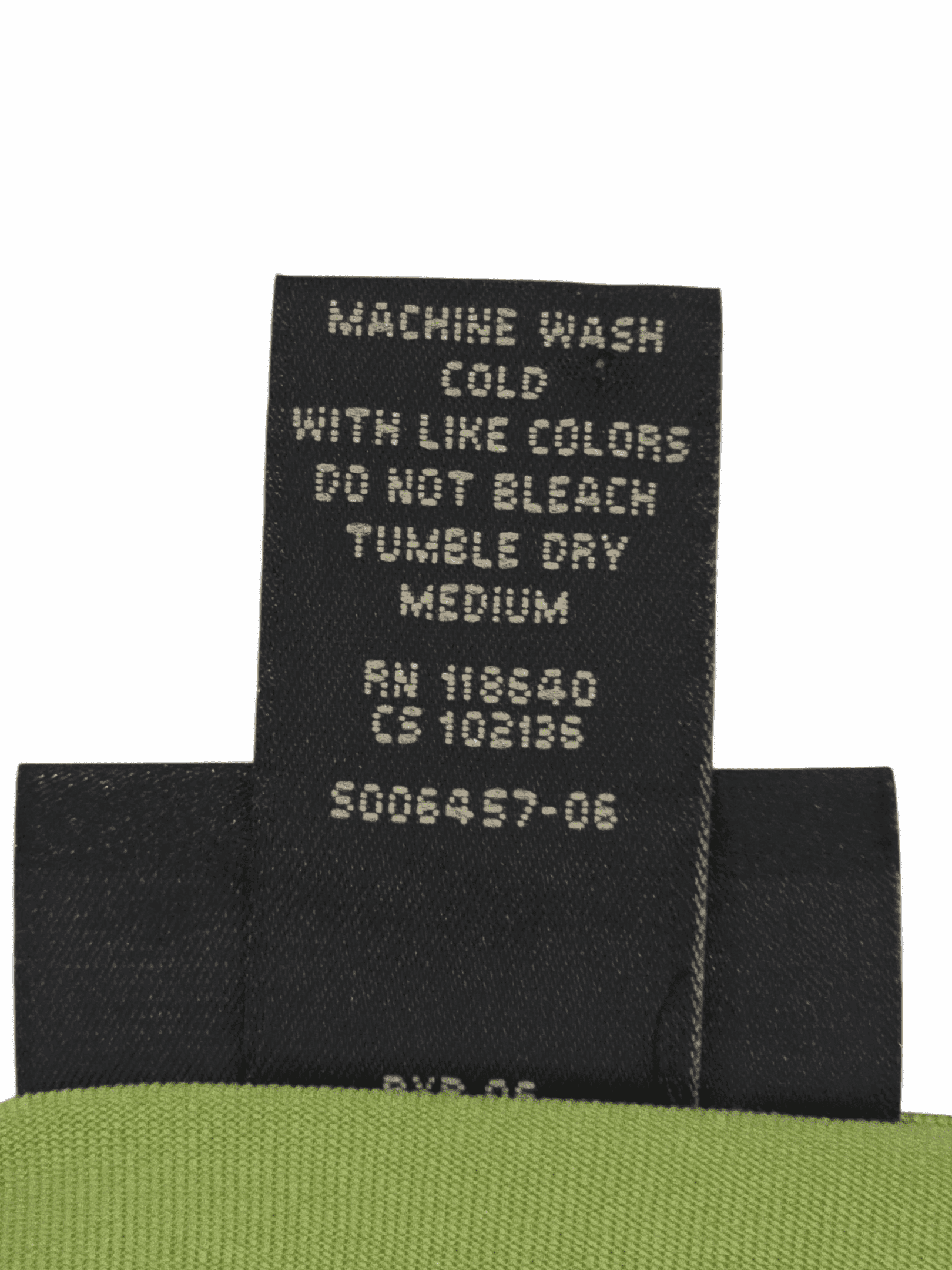 Clothing care label with washing instructions in white text on black fabric.