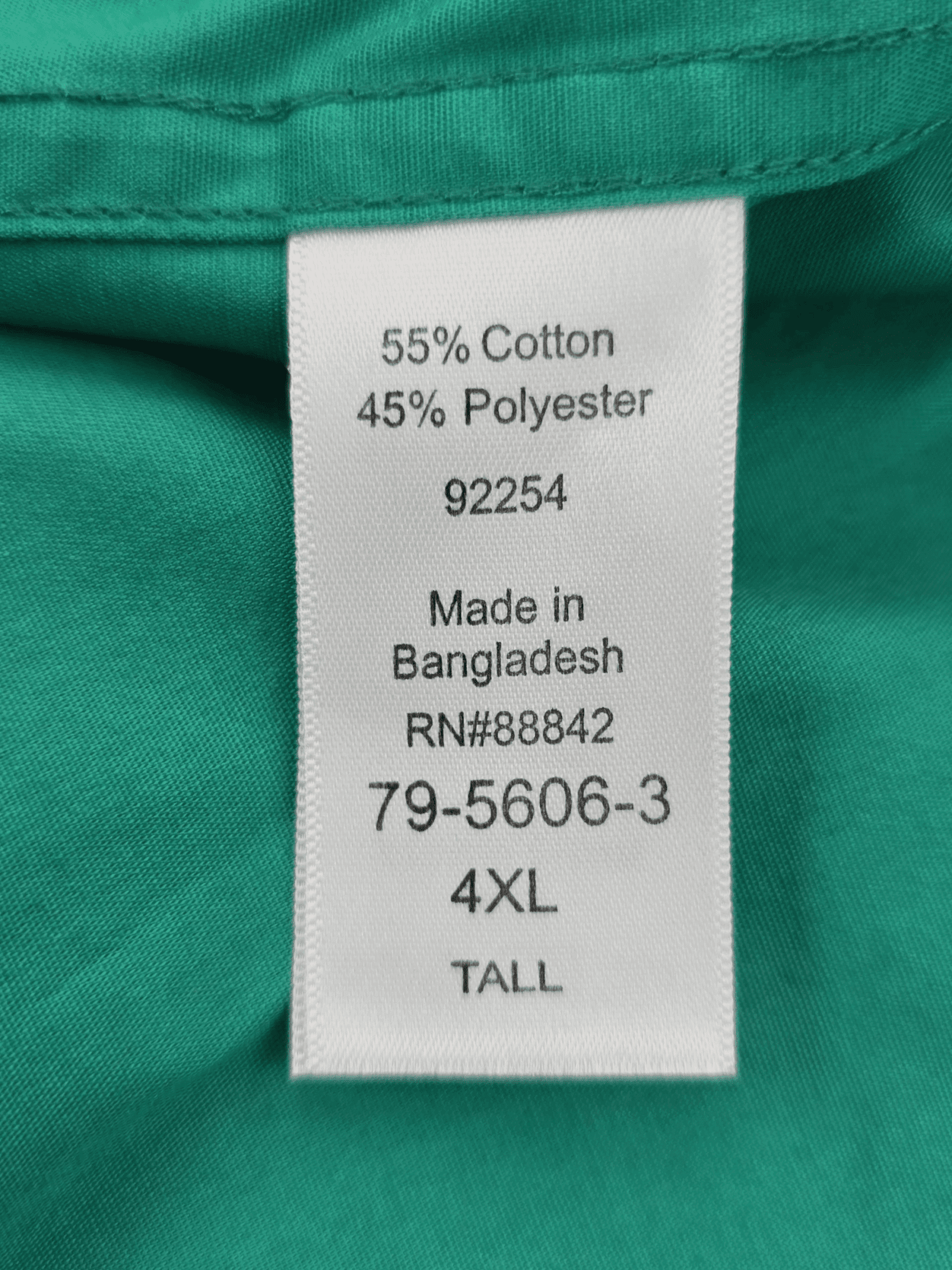 Clothing tag showing fabric content and size information.