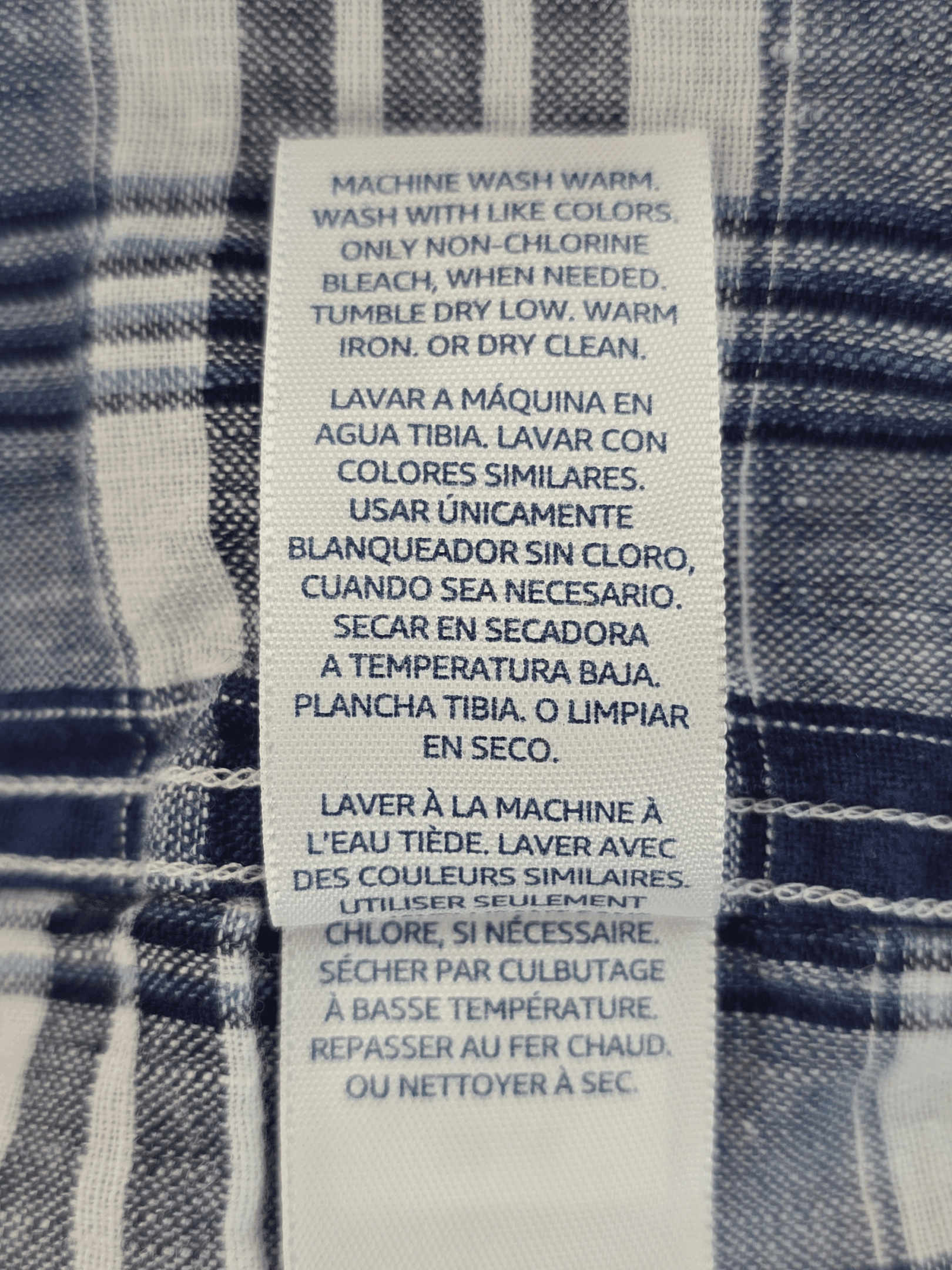 Washing machine instructions in multiple languages on fabric.
