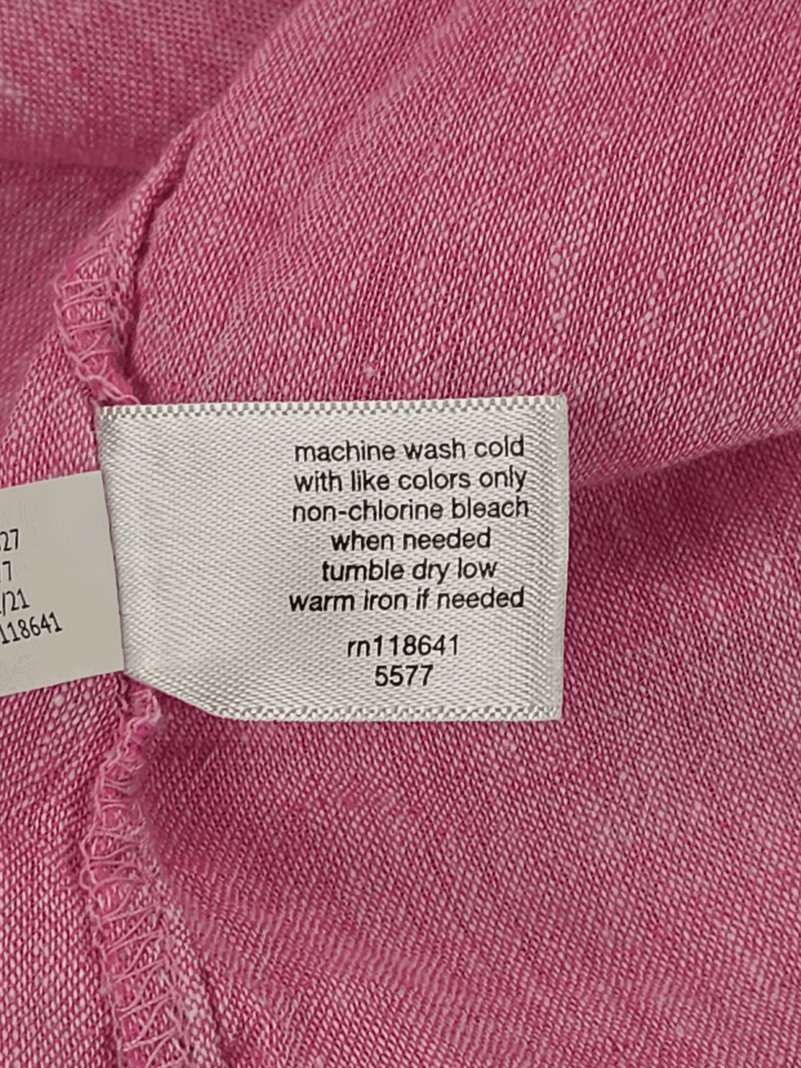Garment care tag for Lane Bryant pink linen blend flutter sleeve peplum top showing washing and drying directions.