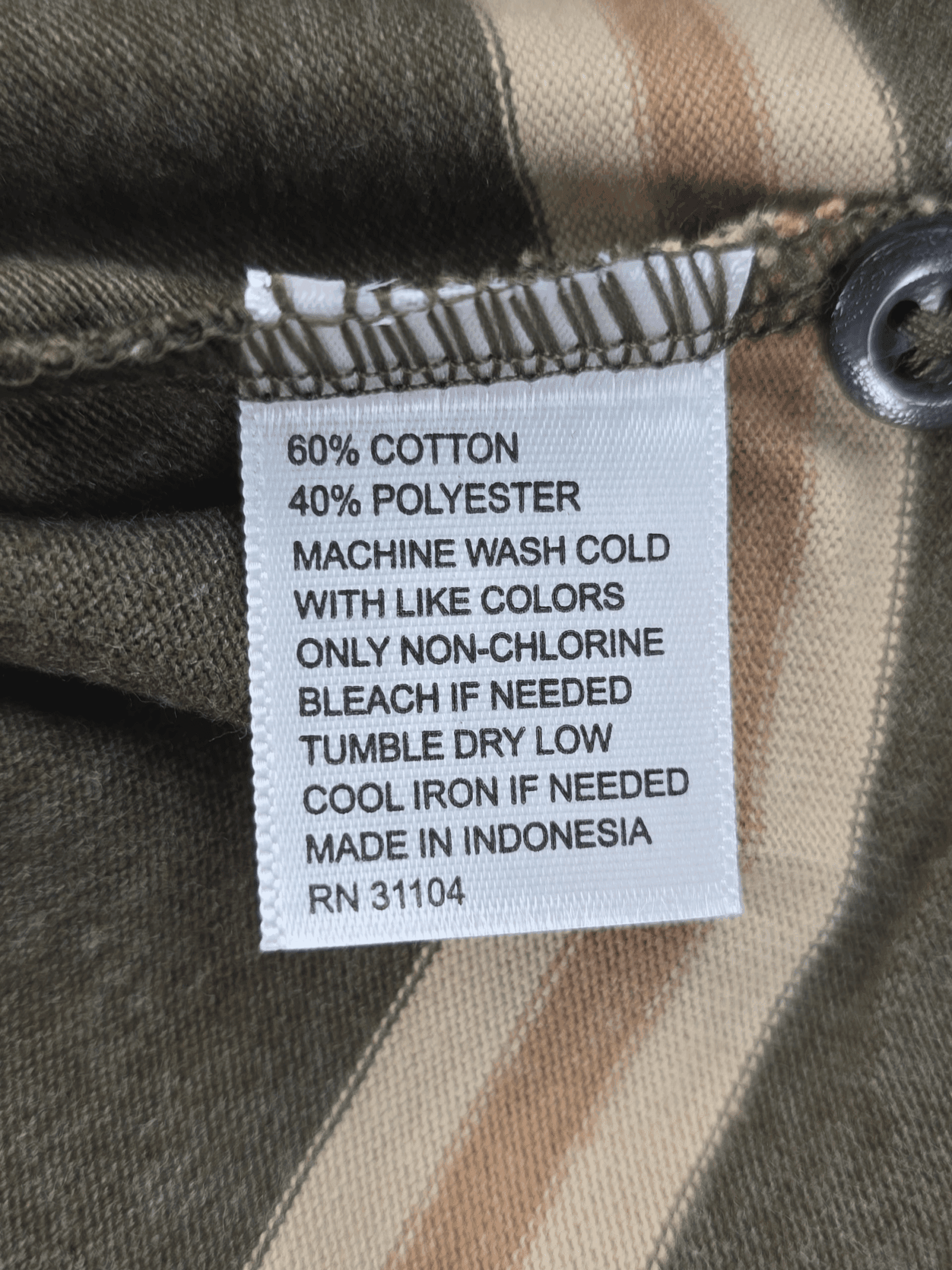 Clothing label detailing fabric composition and care instructions.