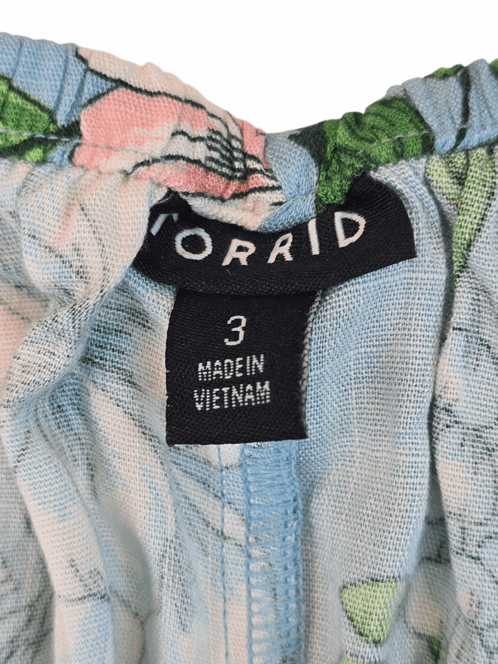 Clothing label showing size and origin information.