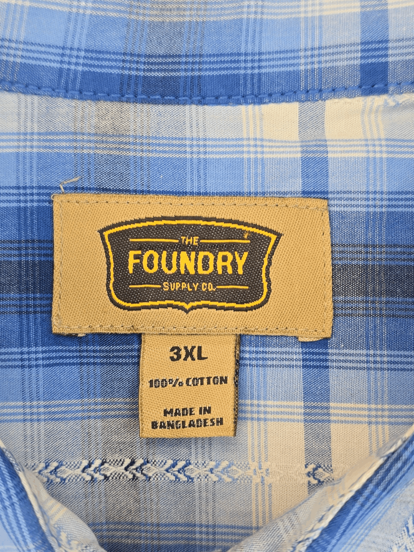 Label showing 'Foundry Supply Co.' on a blue plaid fabric, size 3XL.