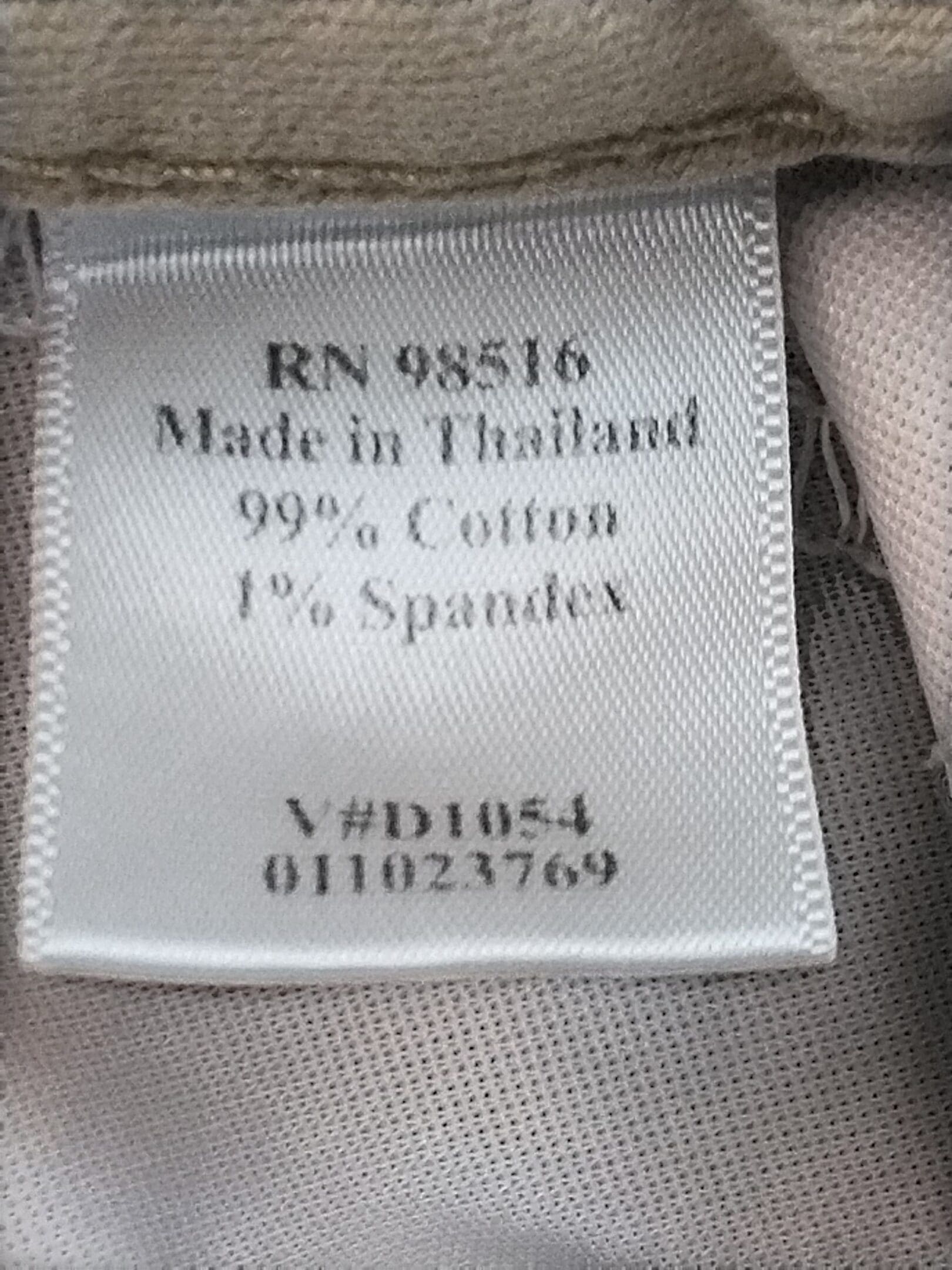 Clothing label showing fabric composition and manufacturing details.