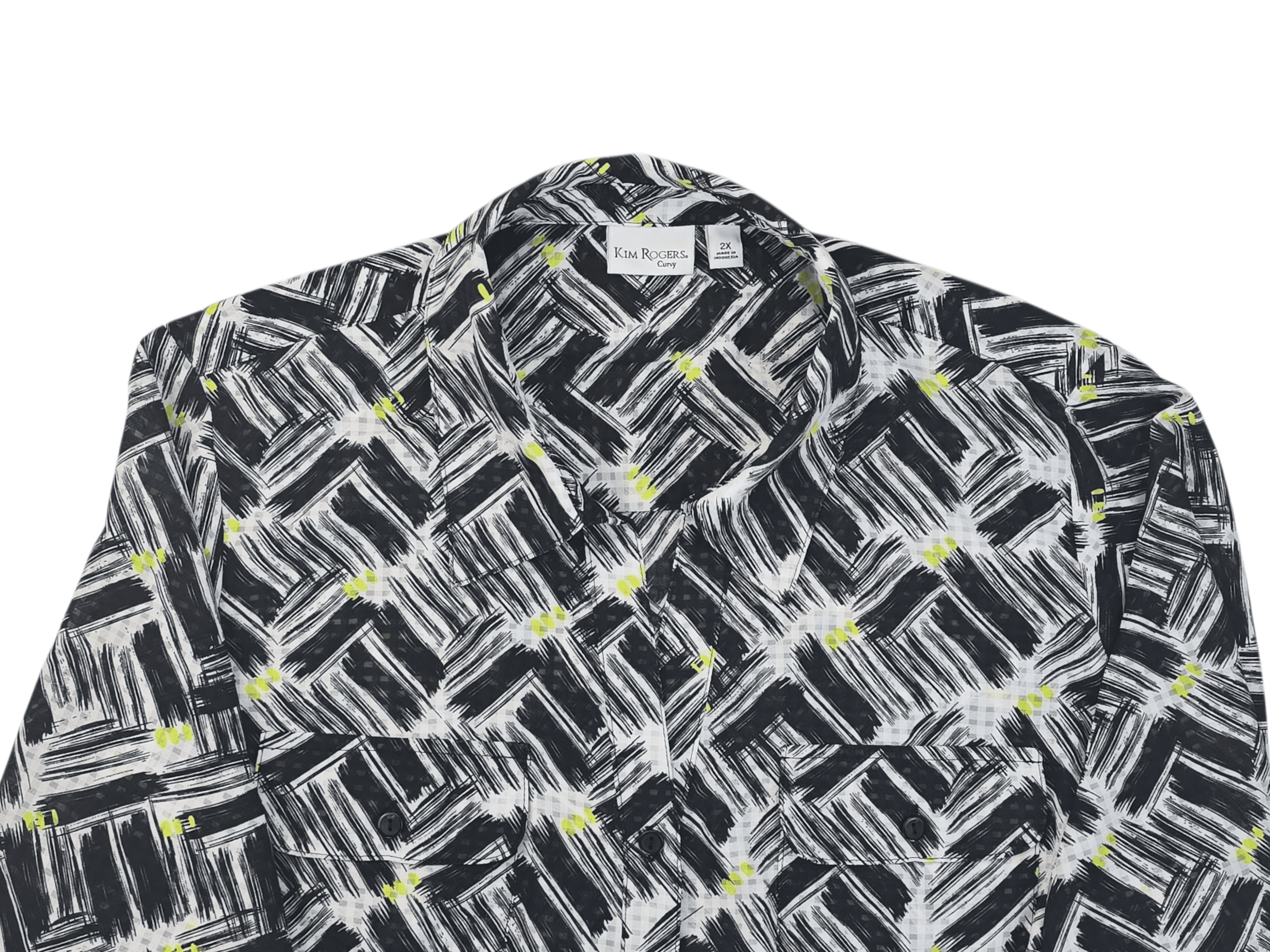 Close-up of Kim Rogers black and white paint stroke roll tab top showing button placket and print detail.