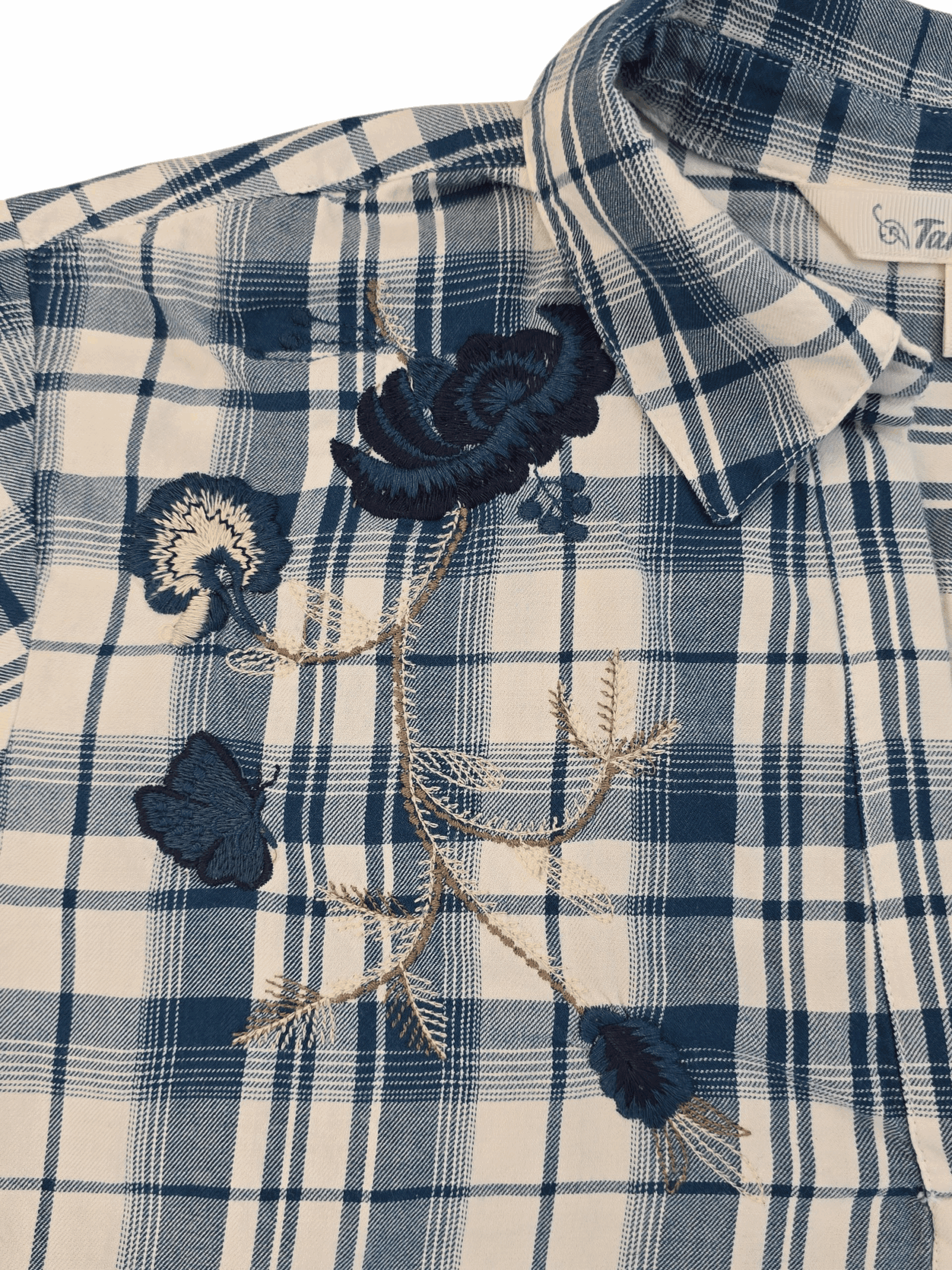 Plaid shirt adorned with decorative fabric flowers and gold chain accents.
