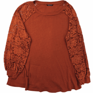 Rust orange sweater with lace balloon sleeves.