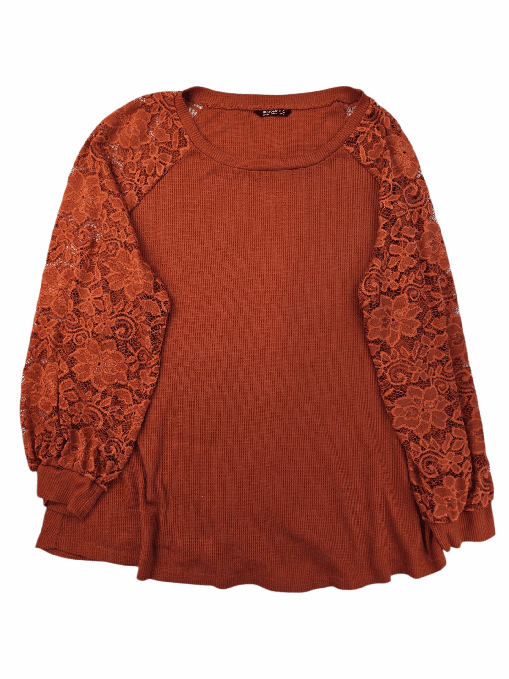 Rust orange sweater with lace balloon sleeves.