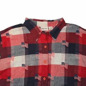 Close-up of Fashion Bug red, white, and blue American flag plaid button-up shirt showing collar, buttons, and pattern detail.