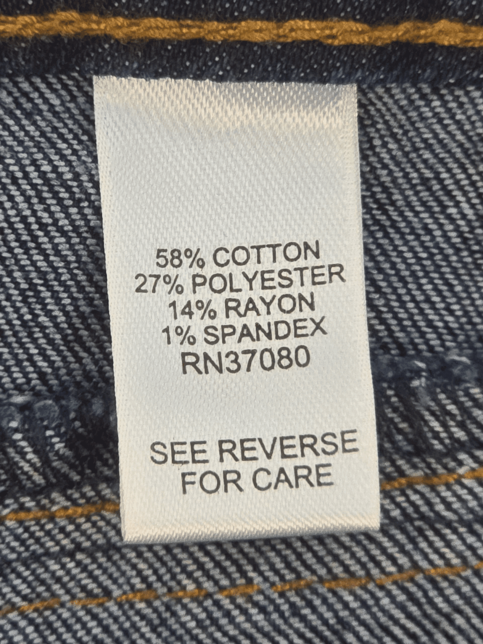 Material content tag showing cotton, polyester, and spandex blend for EST. 1946 denim blue straight-leg jeans.