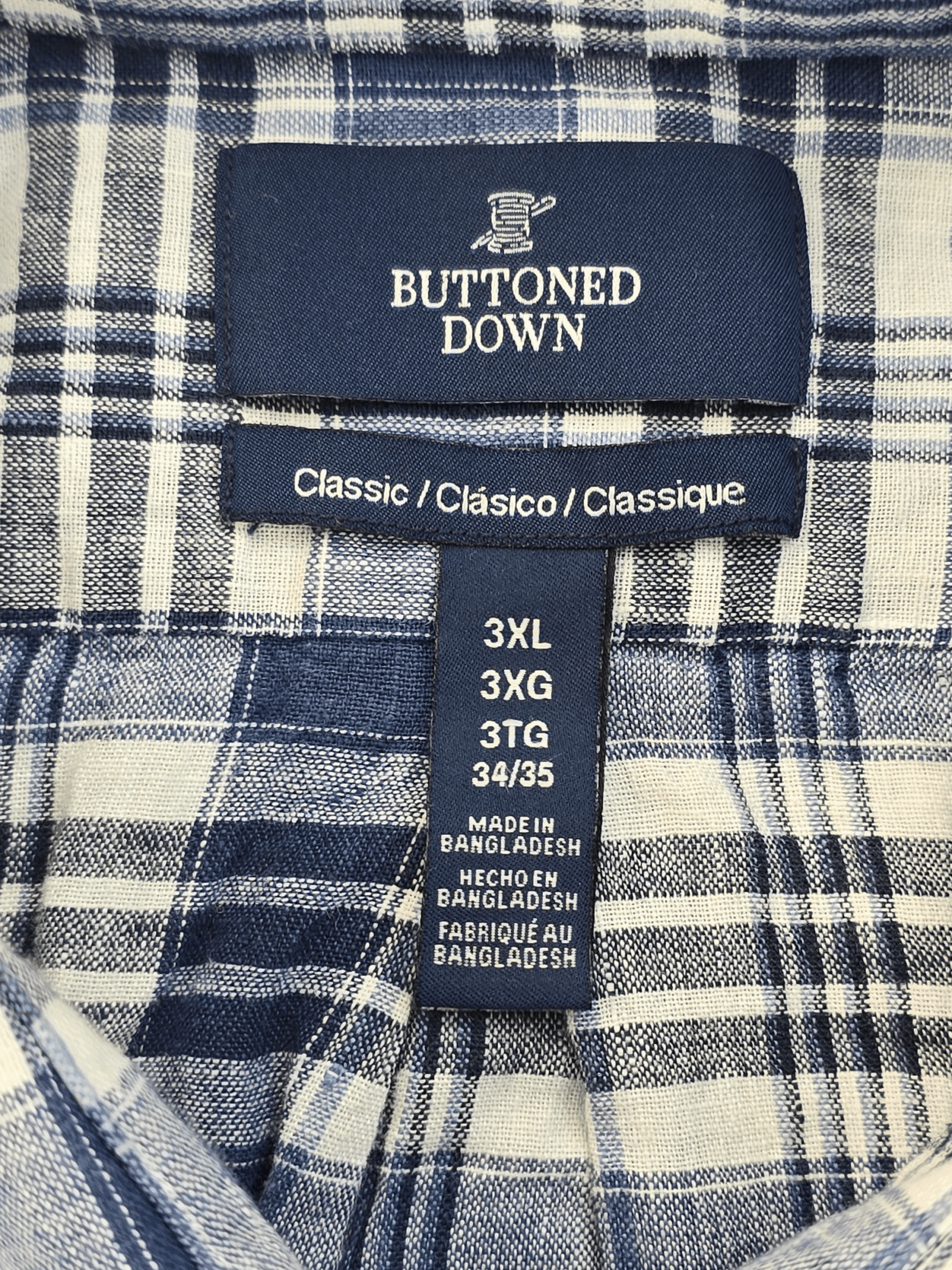 Label on a blue plaid shirt showing size 3XL and care instructions.