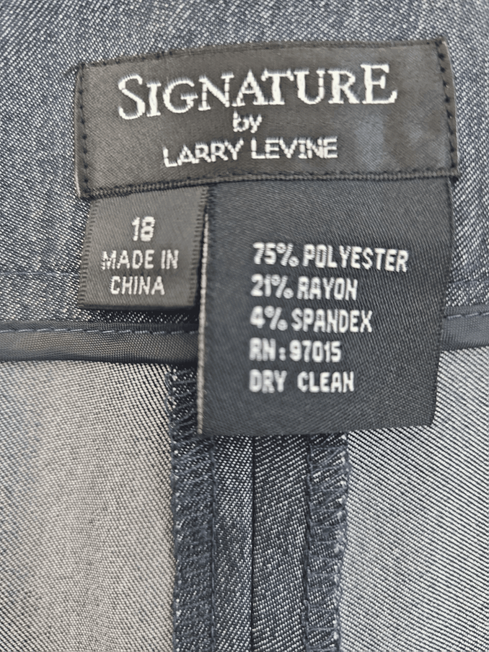 Clothing label with fabric composition and care instructions.