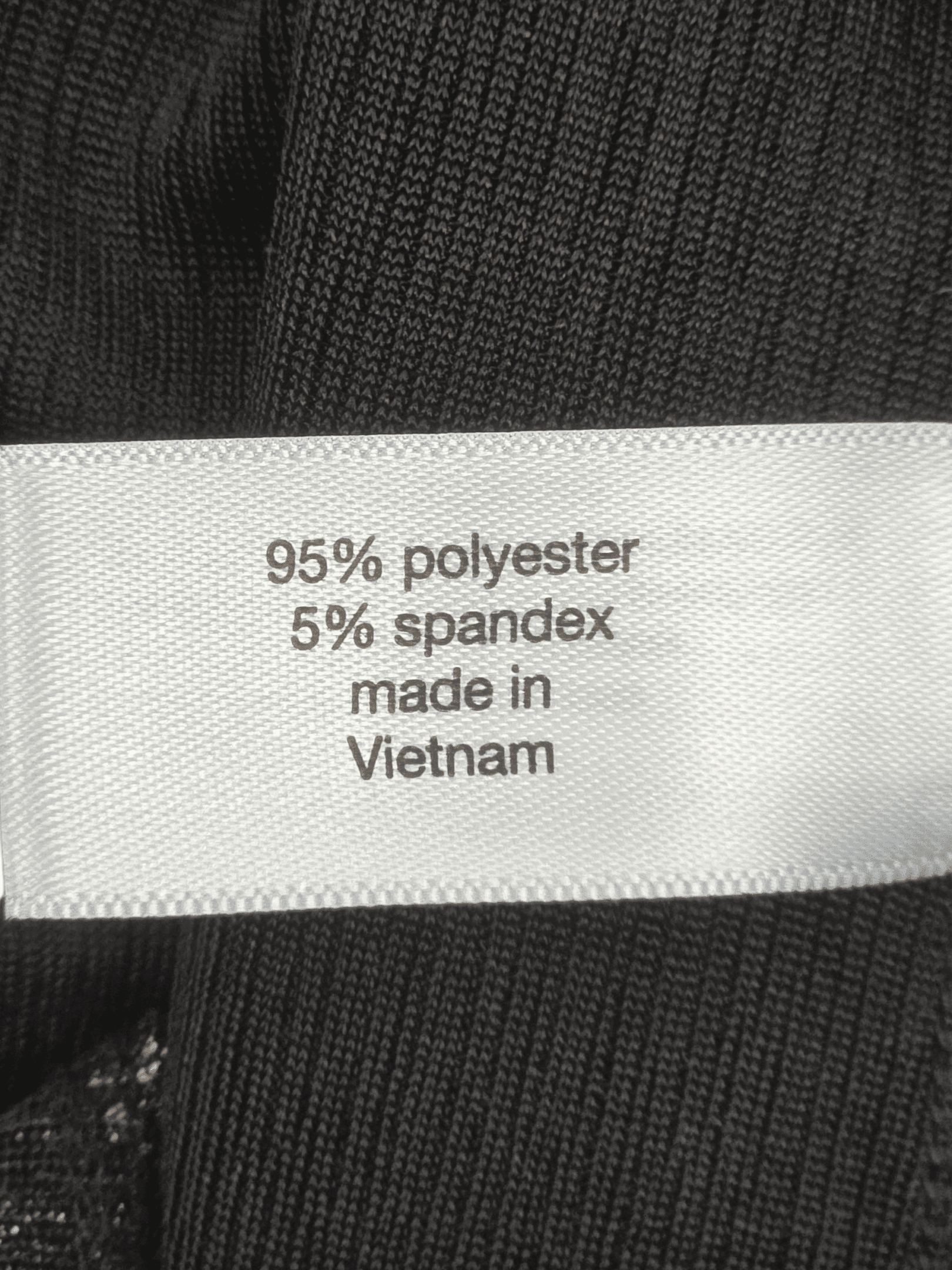 Fabric content tag from Lane Bryant shimmering copper pullover top women’s plus size 22/24