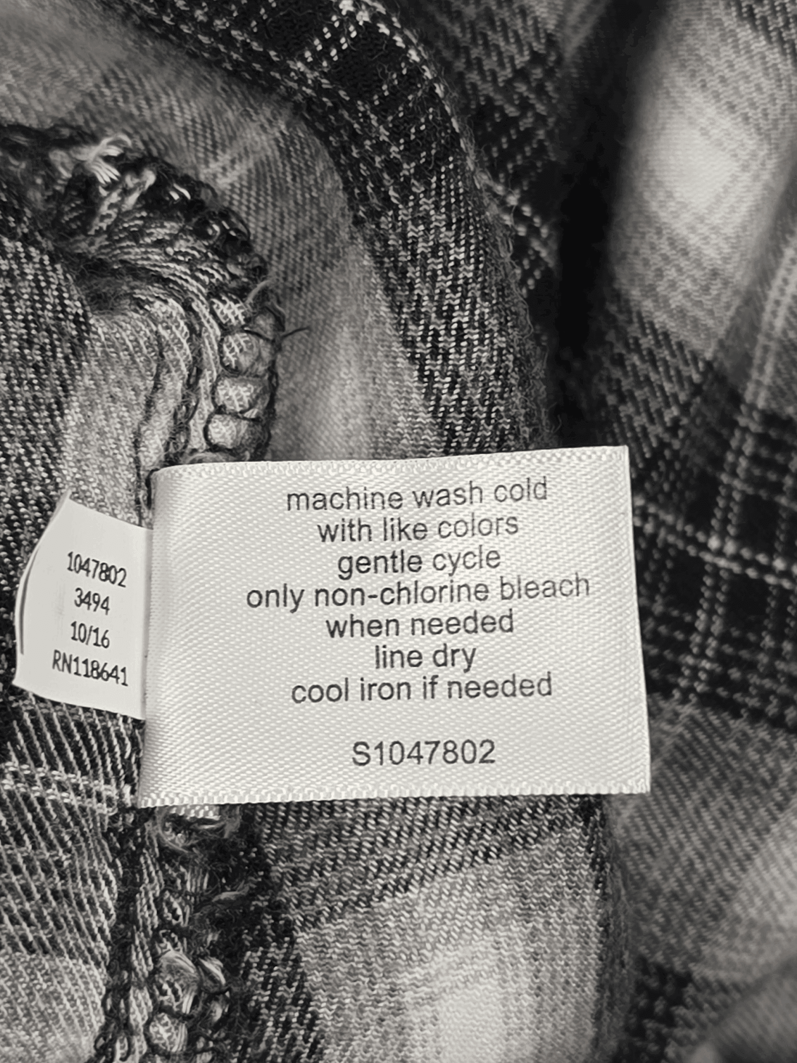 Garment care instruction tag from Lane Bryant black, gray, and white plaid flannel shirt women’s plus size 22/24