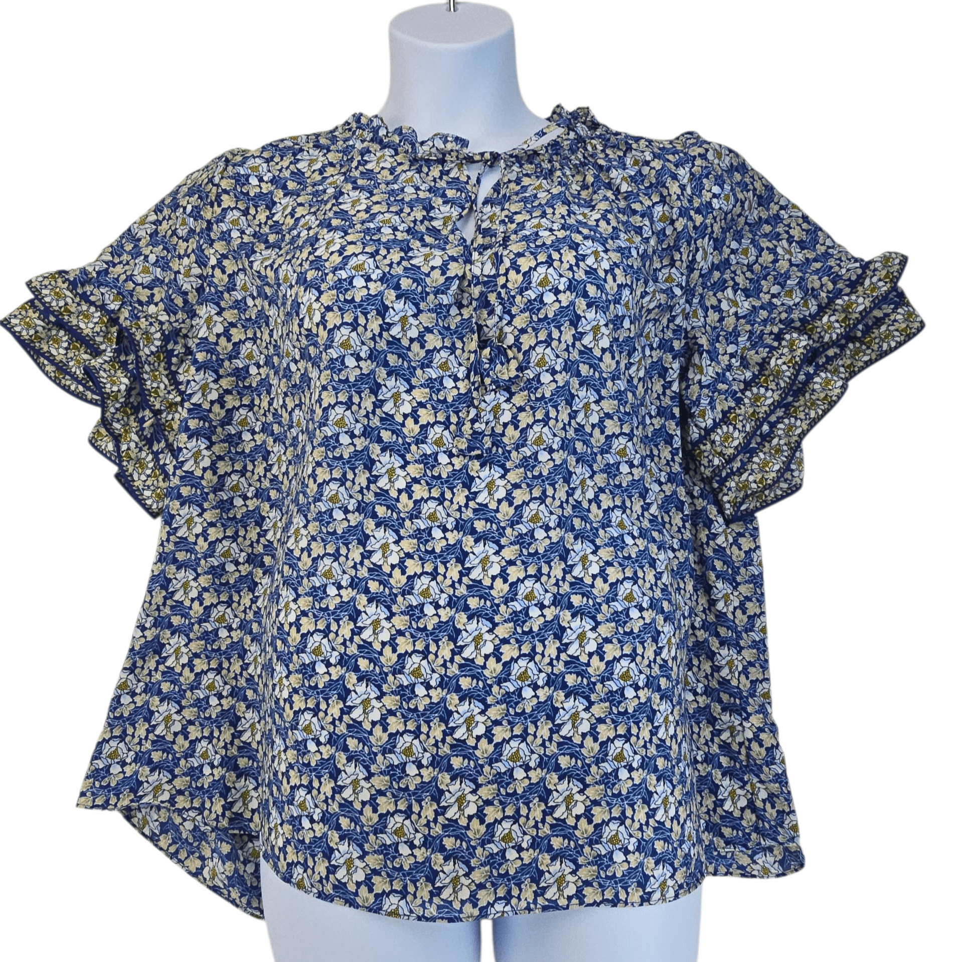 Blue floral blouse with ruffled sleeves on a mannequin.