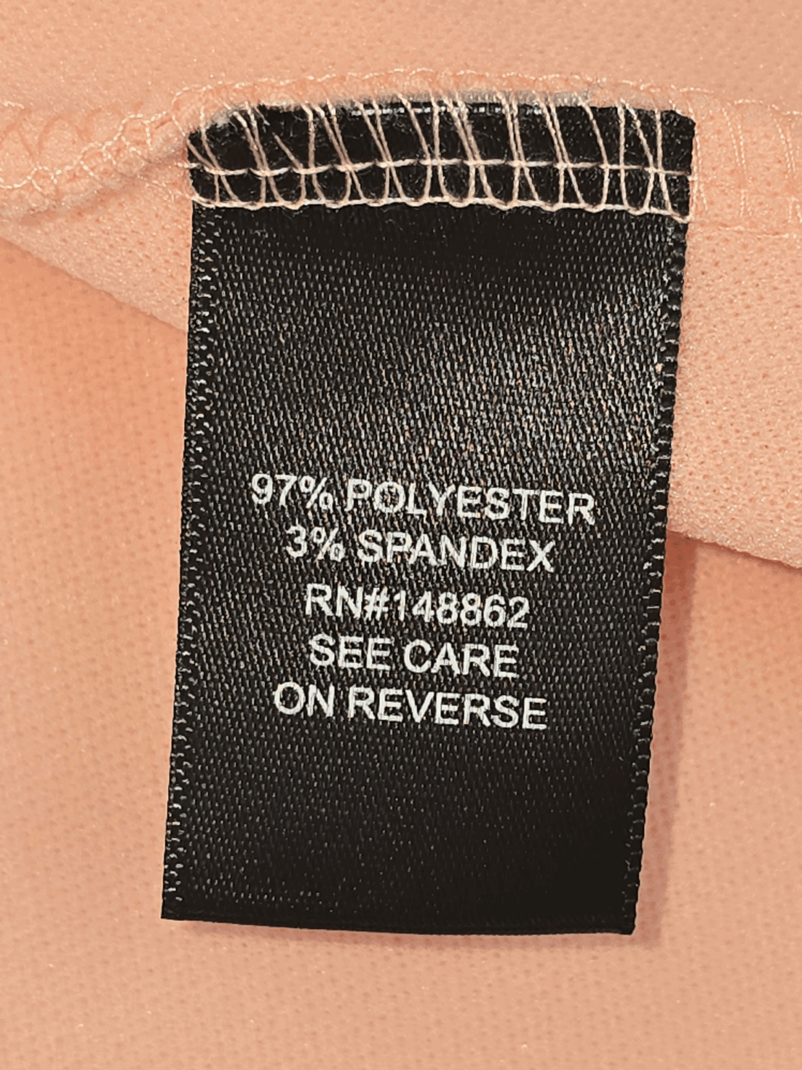 Clothing tag showing fabric composition and care instructions.