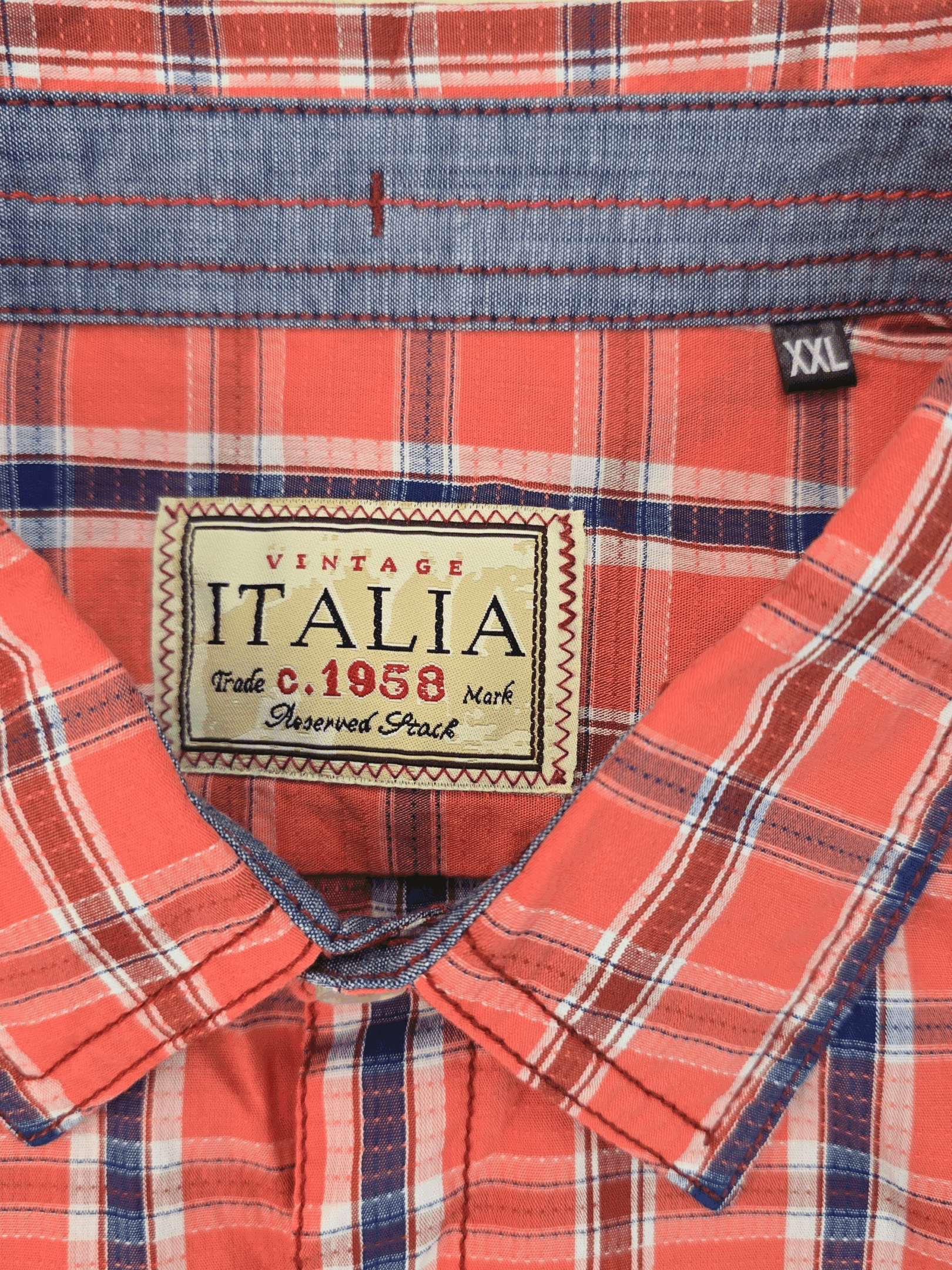 Close-up of a red plaid shirt with an Italia label.