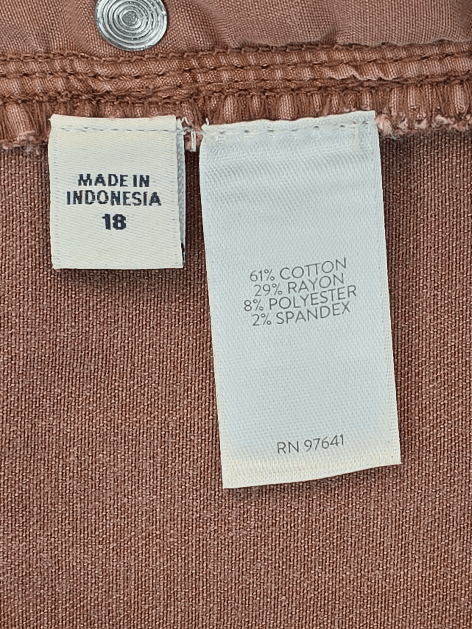 Material and care tag showing cotton, rayon, polyester, spandex blend and machine wash instructions