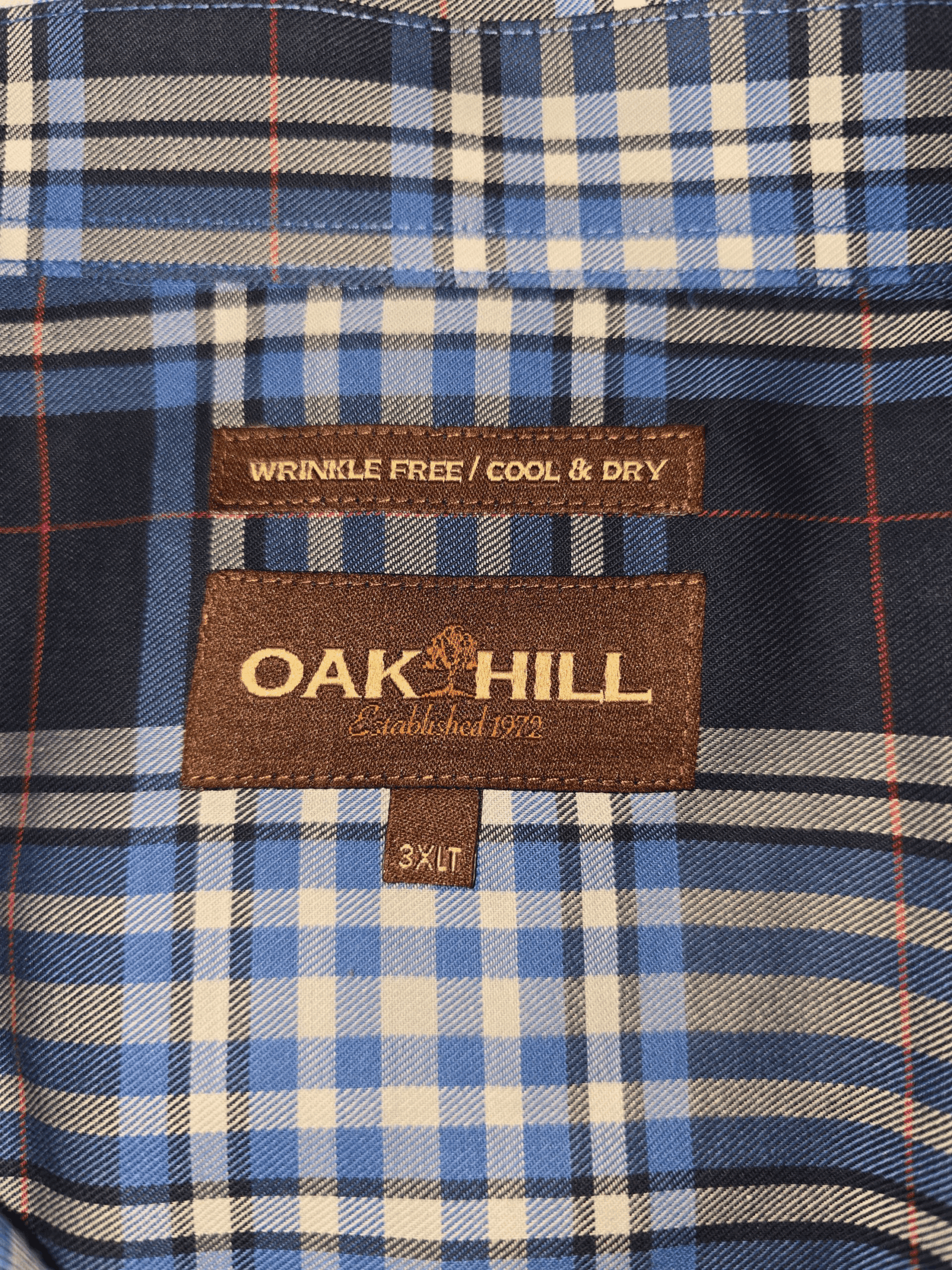 Oak Hill brand and size tag on blue and white plaid wrinkle-free button-up shirt in men’s size 3XLT.
