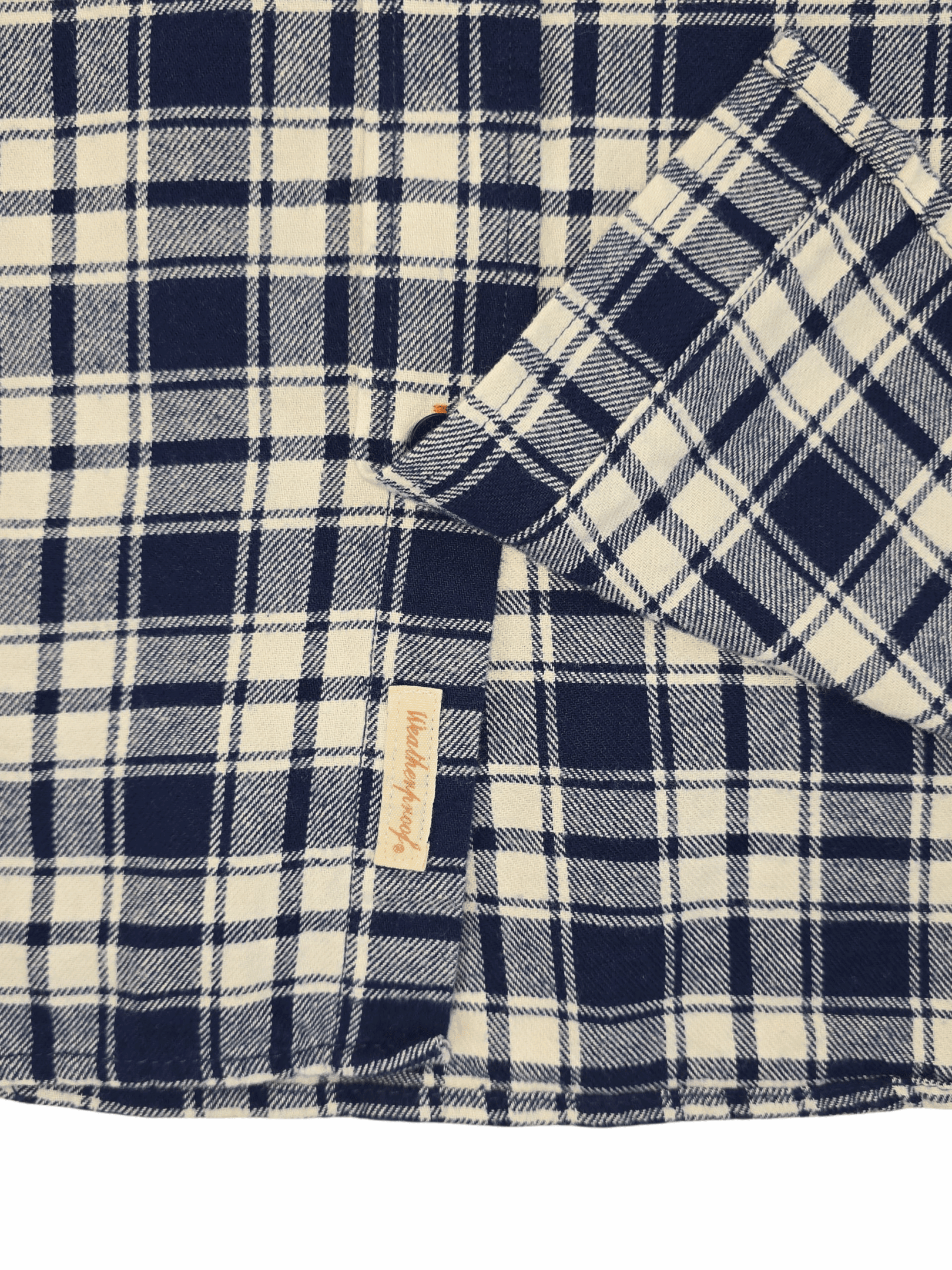 Close-up of a black and white checkered fabric with a small beige label.