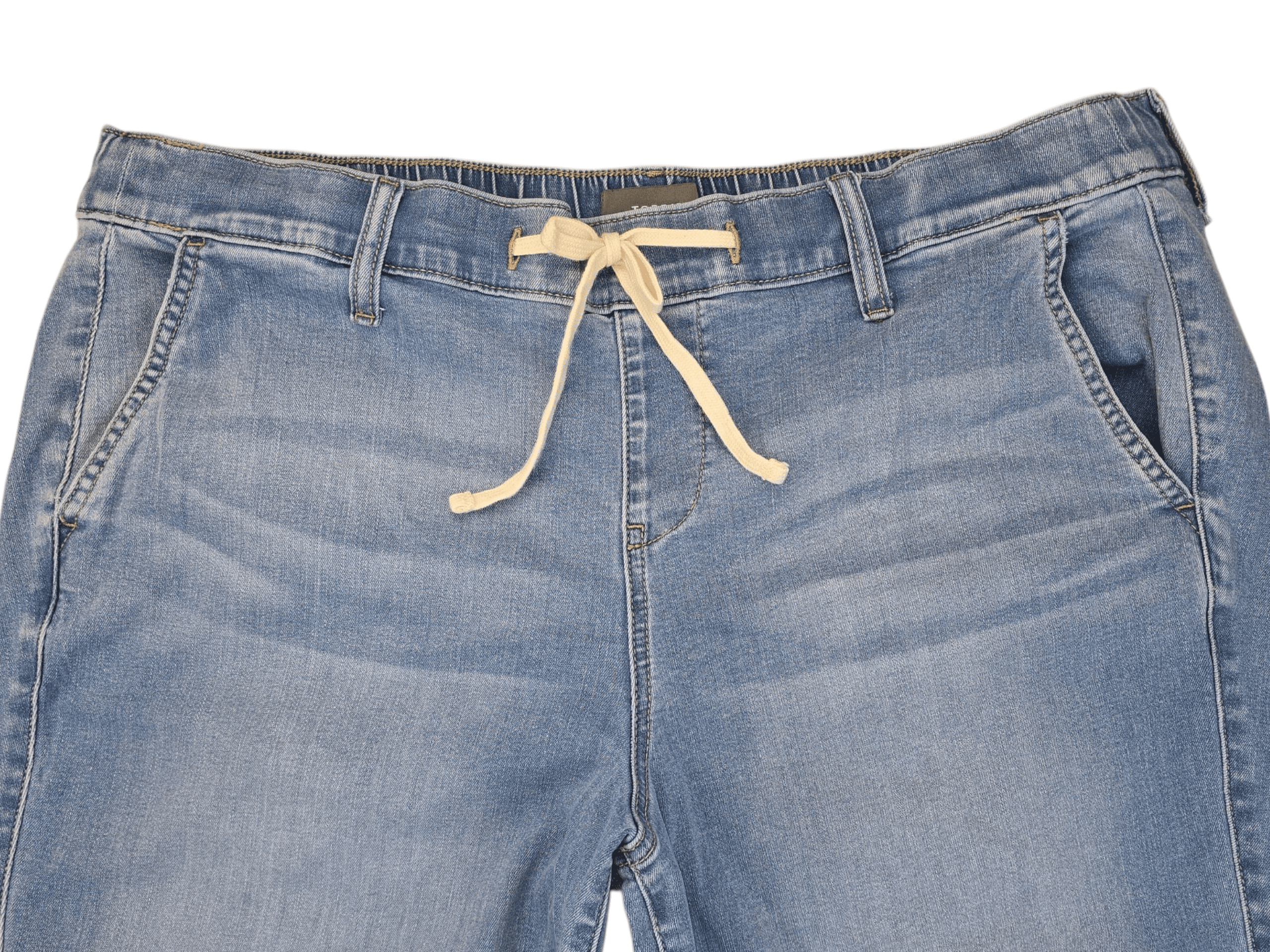 Close-up of Torrid light blue denim ankle pants front showing tie closure, pockets and fabric texture.